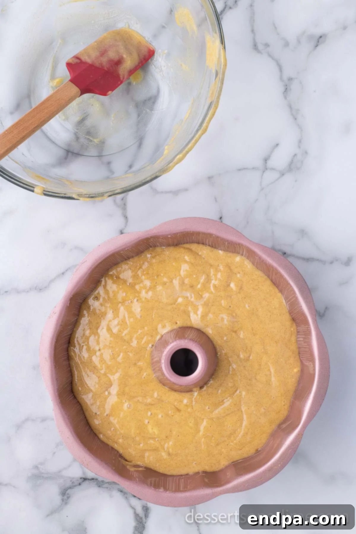 Unforgettable Craving Cake 5 Image of cake batter being poured into a greased Bundt pan.