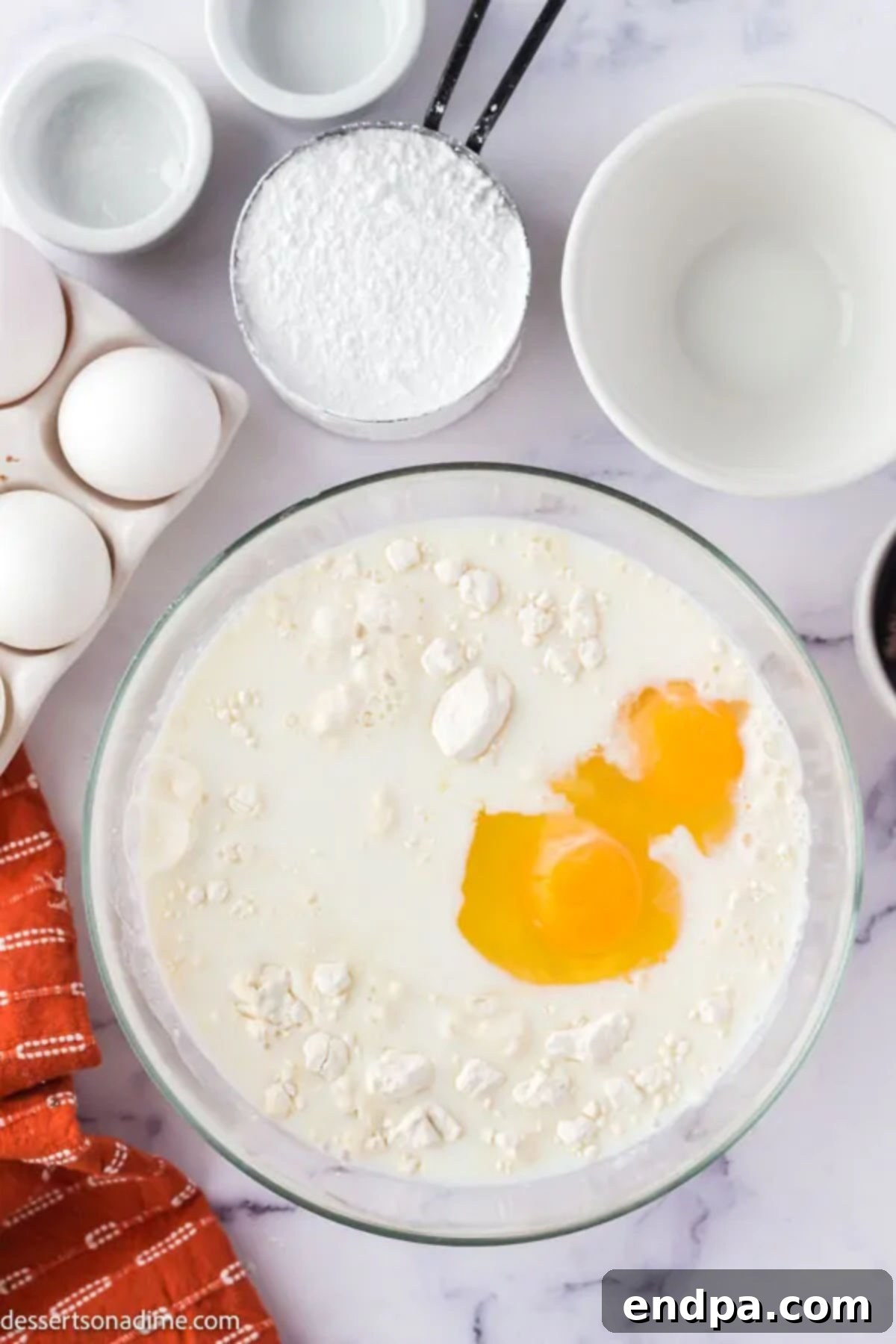 Wet and dry ingredients combined in a bowl for the funnel cake batter.