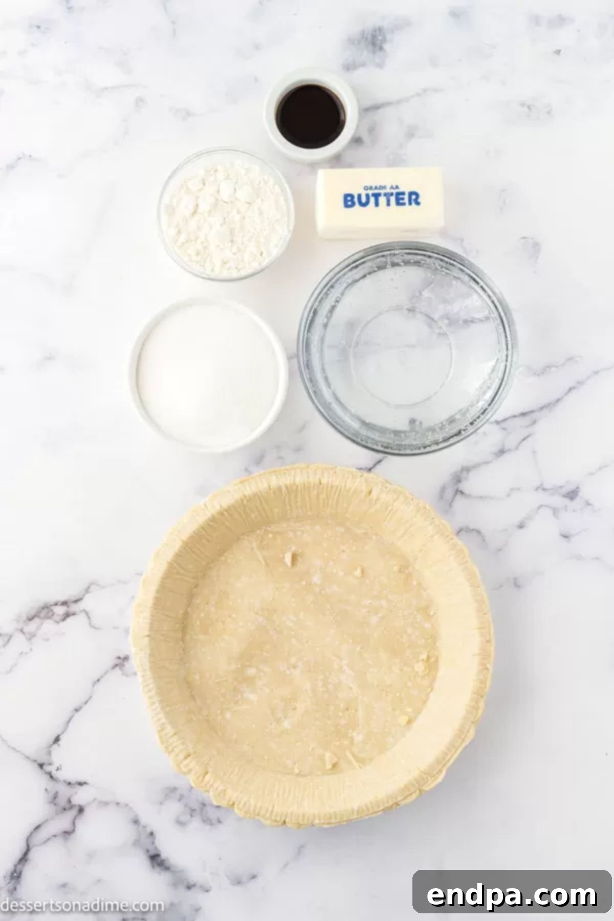 Ingredients for Sprite pie laid out: Sugar, flour, grated butter, a frozen pie crust, a can of Sprite, and vanilla extract.