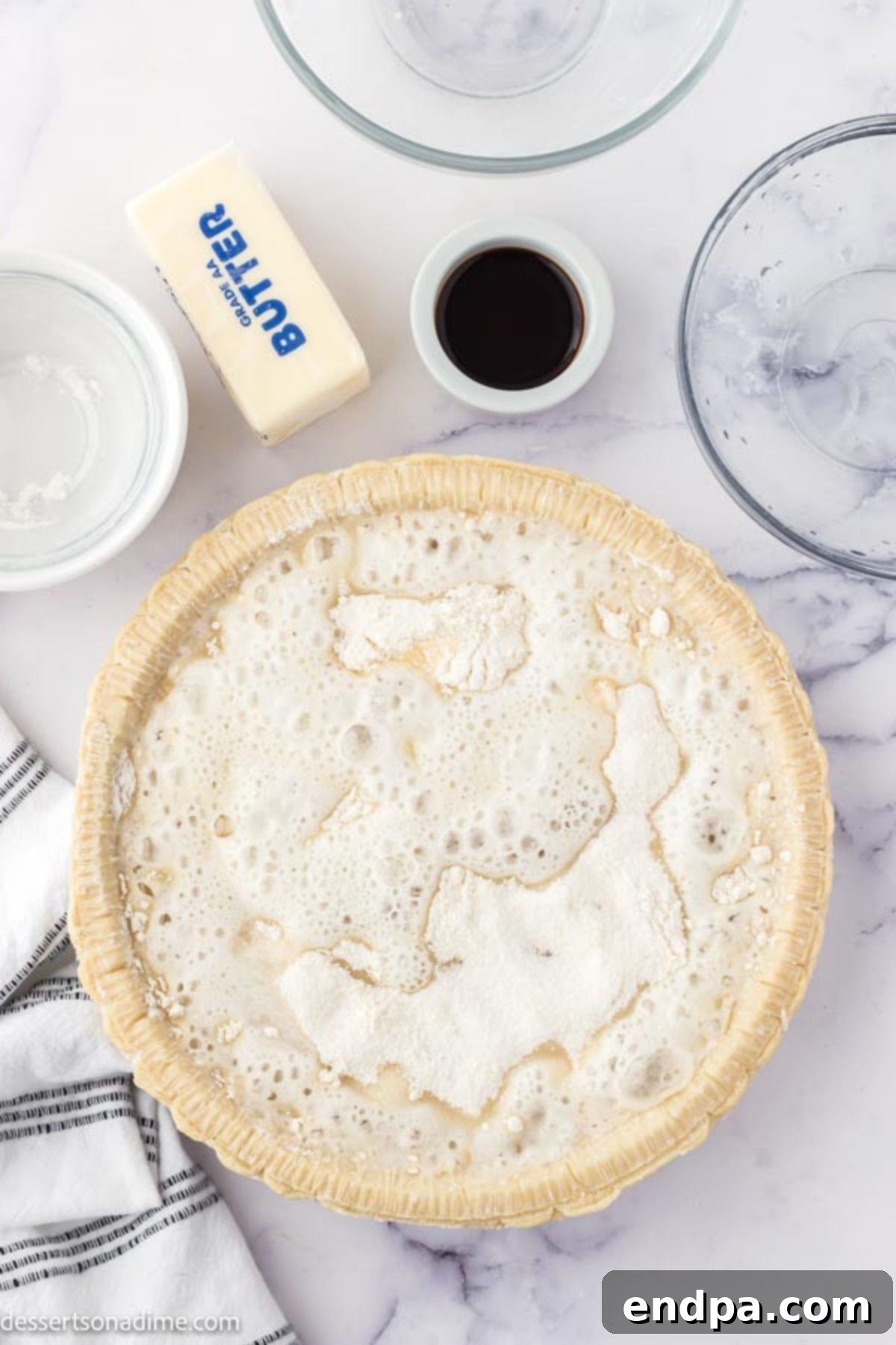 The sugar and flour mixture being evenly dispersed over the Sprite in the pie crust.