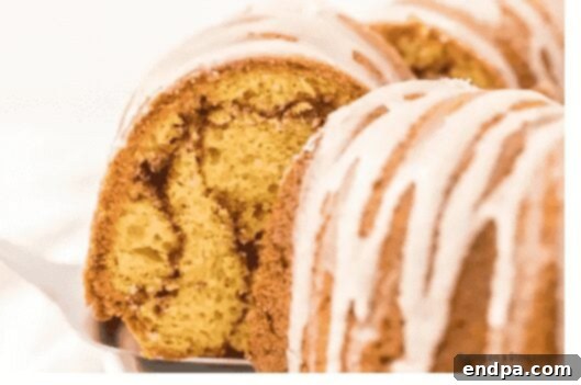 An elegant Cinnamon Bundt Cake drizzled with a sweet white glaze, perfect for a celebration.