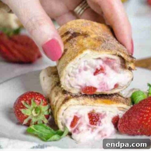 Air Fryer Strawberry Cheesecake Chimichangas, crispy and golden, filled with creamy strawberry cheesecake.