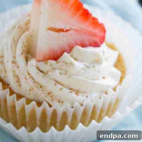 Individual Tres Leches Cupcakes, soaked in milk and topped with whipped cream and a cherry.