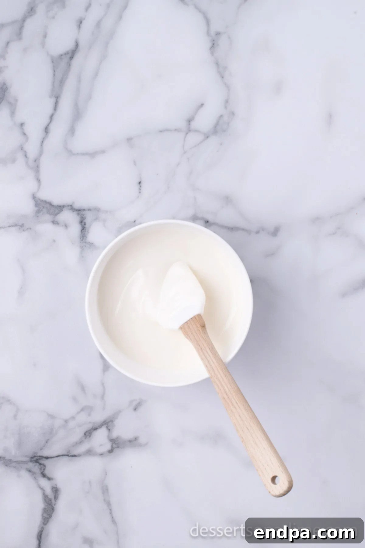 Smoothly melted white candy melts in a microwave-safe bowl.