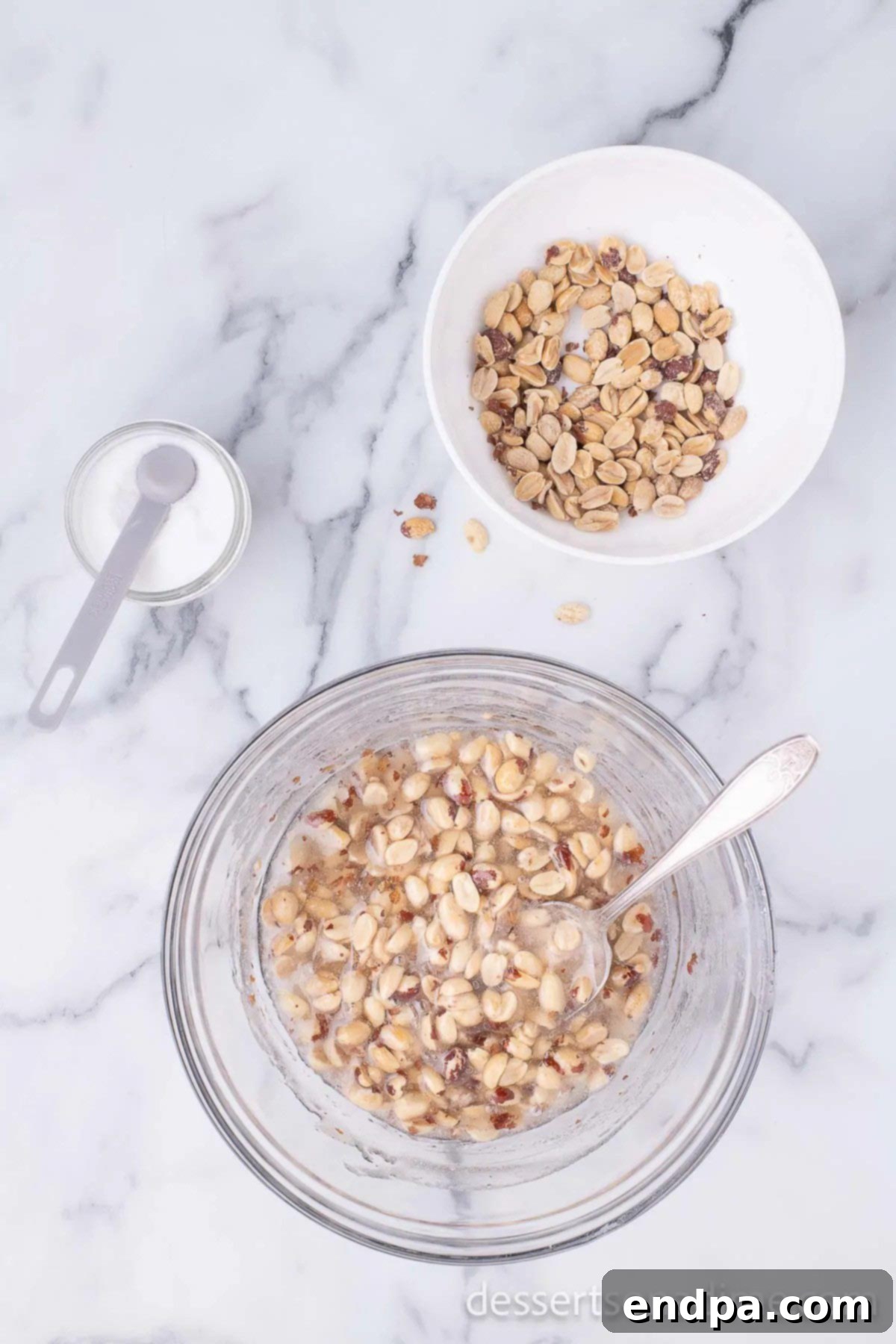 Peanuts and salt added to the hot corn syrup and sugar mixture.
