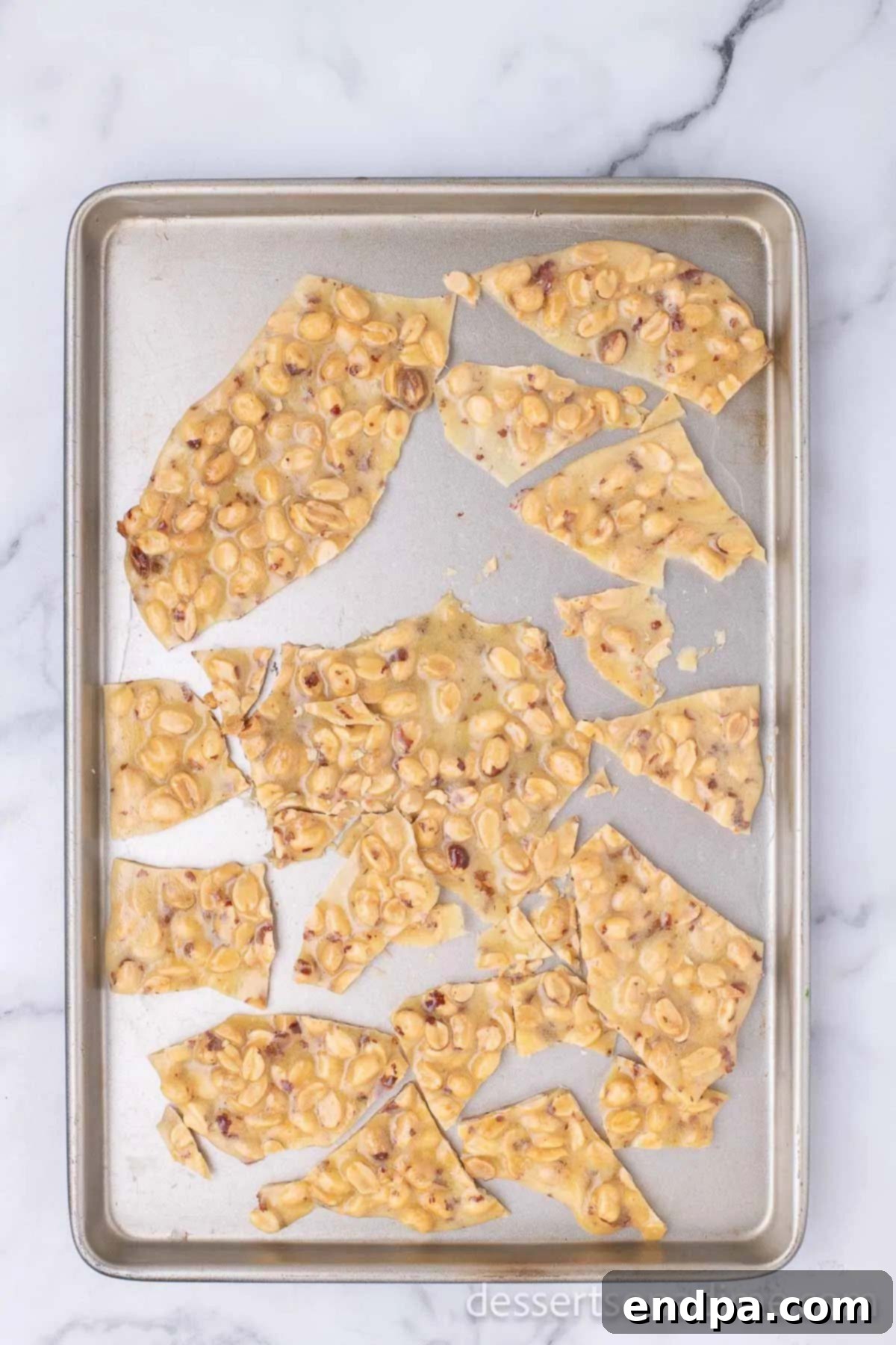 Hardened peanut brittle broken into rustic pieces.