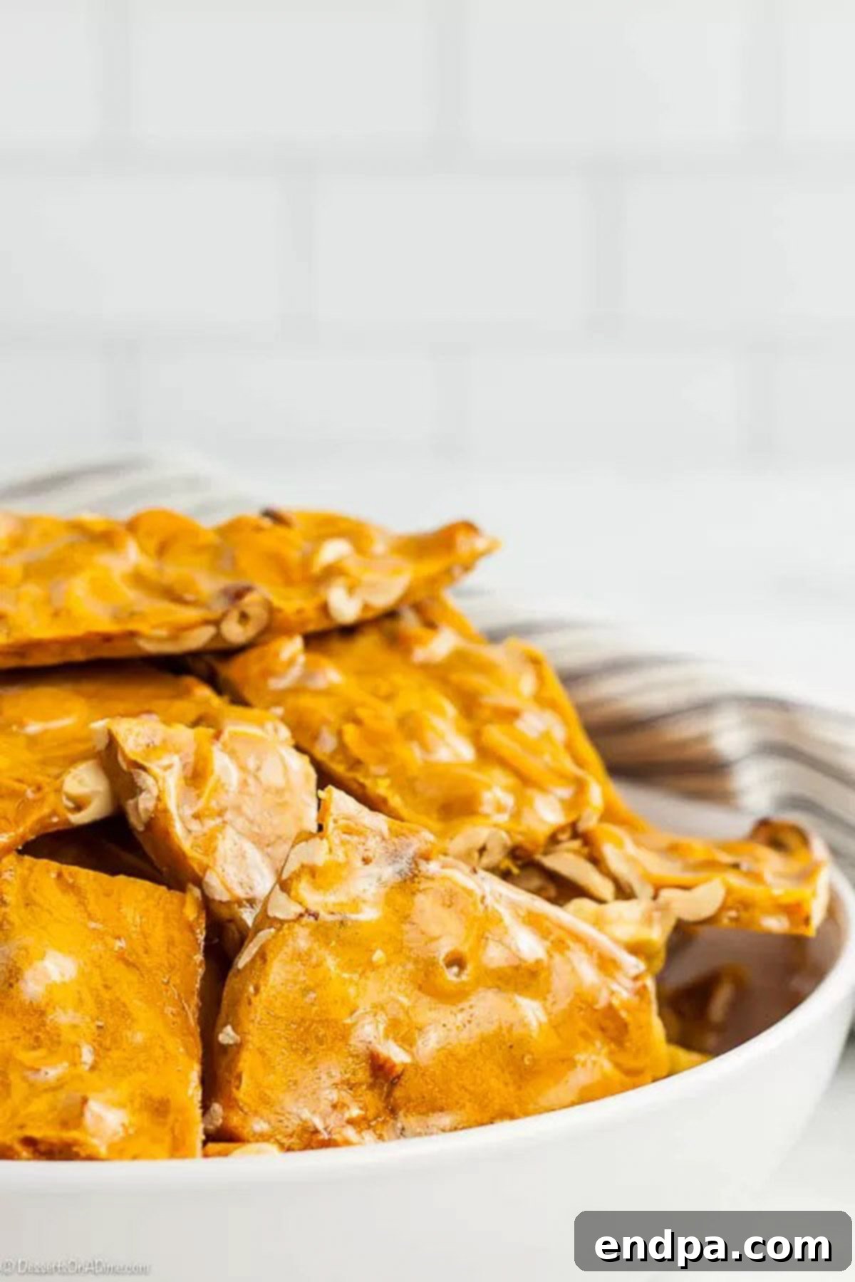 A bowl filled with delicious homemade peanut brittle pieces, ready to serve.