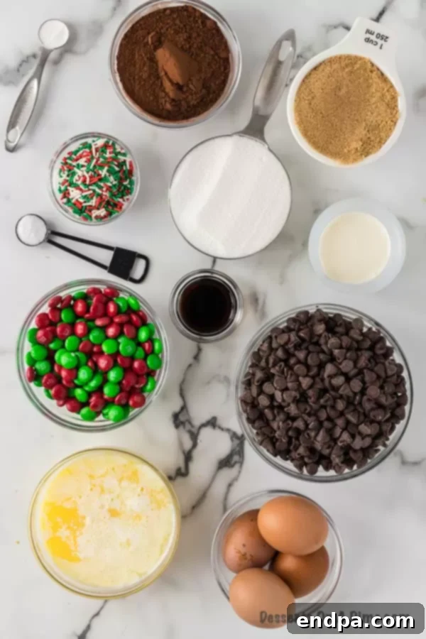 Merry & Bright Brownies 3 Ingredients for Christmas Brownies including flour, sugar, sprinkles, eggs, butter, and chocolate chips laid out on a table.