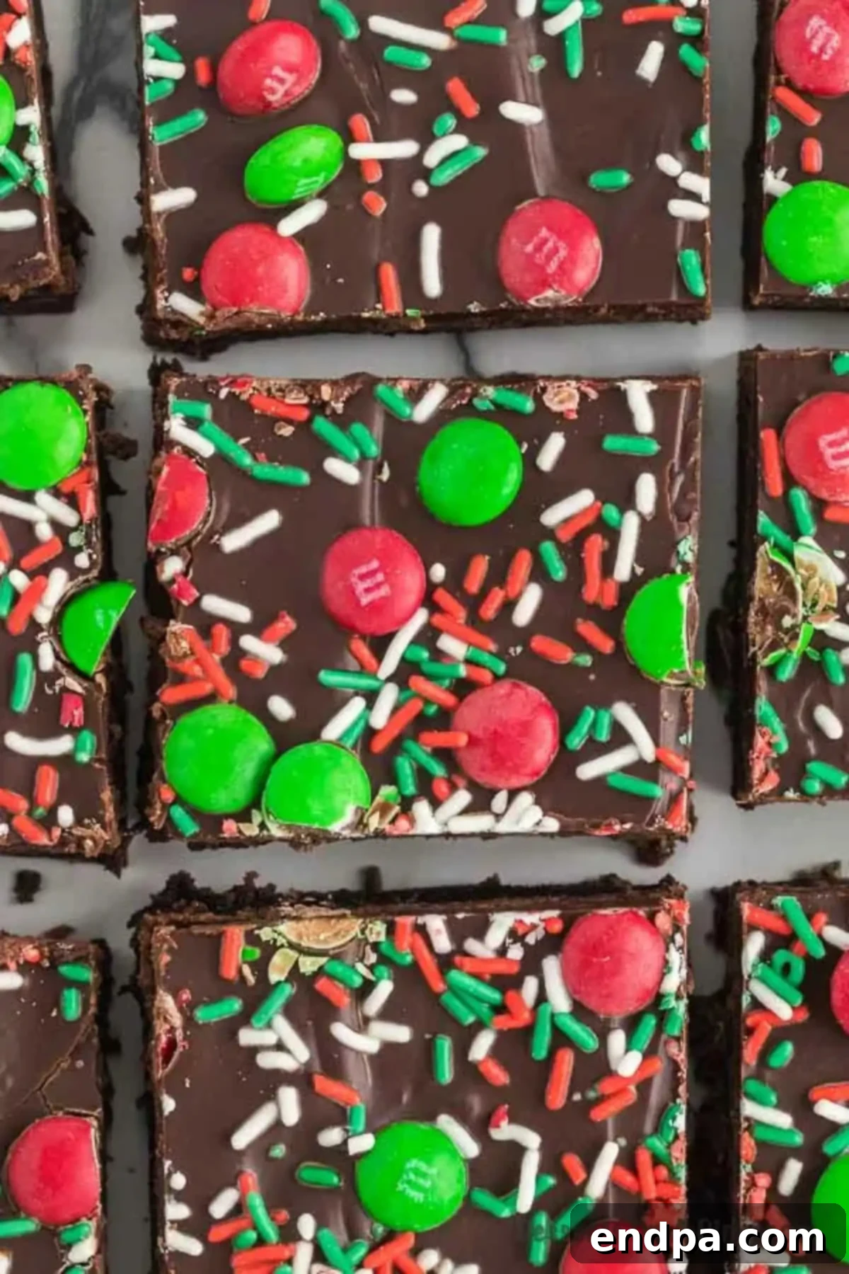 Merry & Bright Brownies 4 Christmas Brownies cut into perfect squares, showcasing the festive M&Ms and ganache topping.