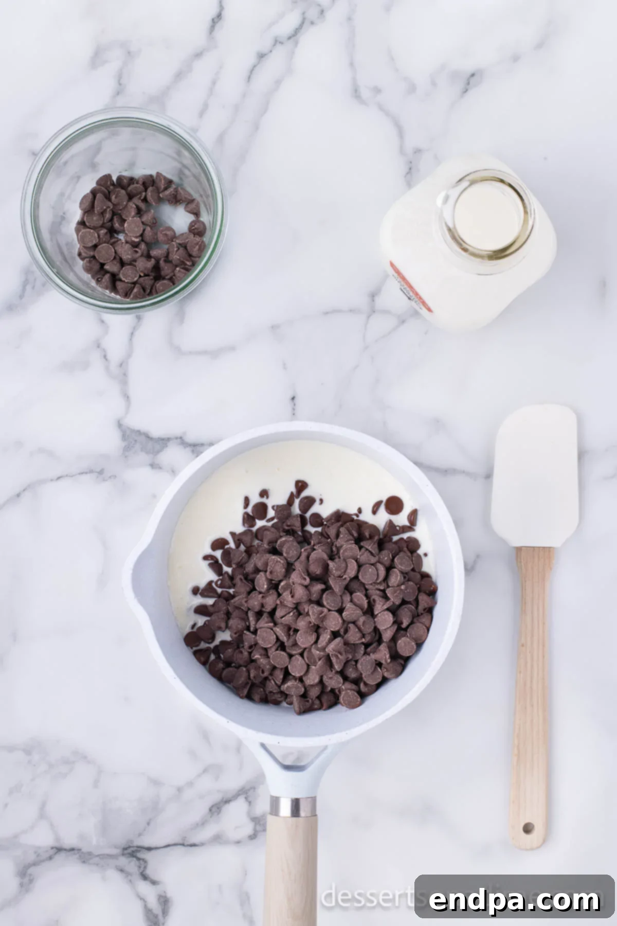 Merry & Bright Brownies 9 Saucepan with hot cream and chocolate chips melting together to form ganache.