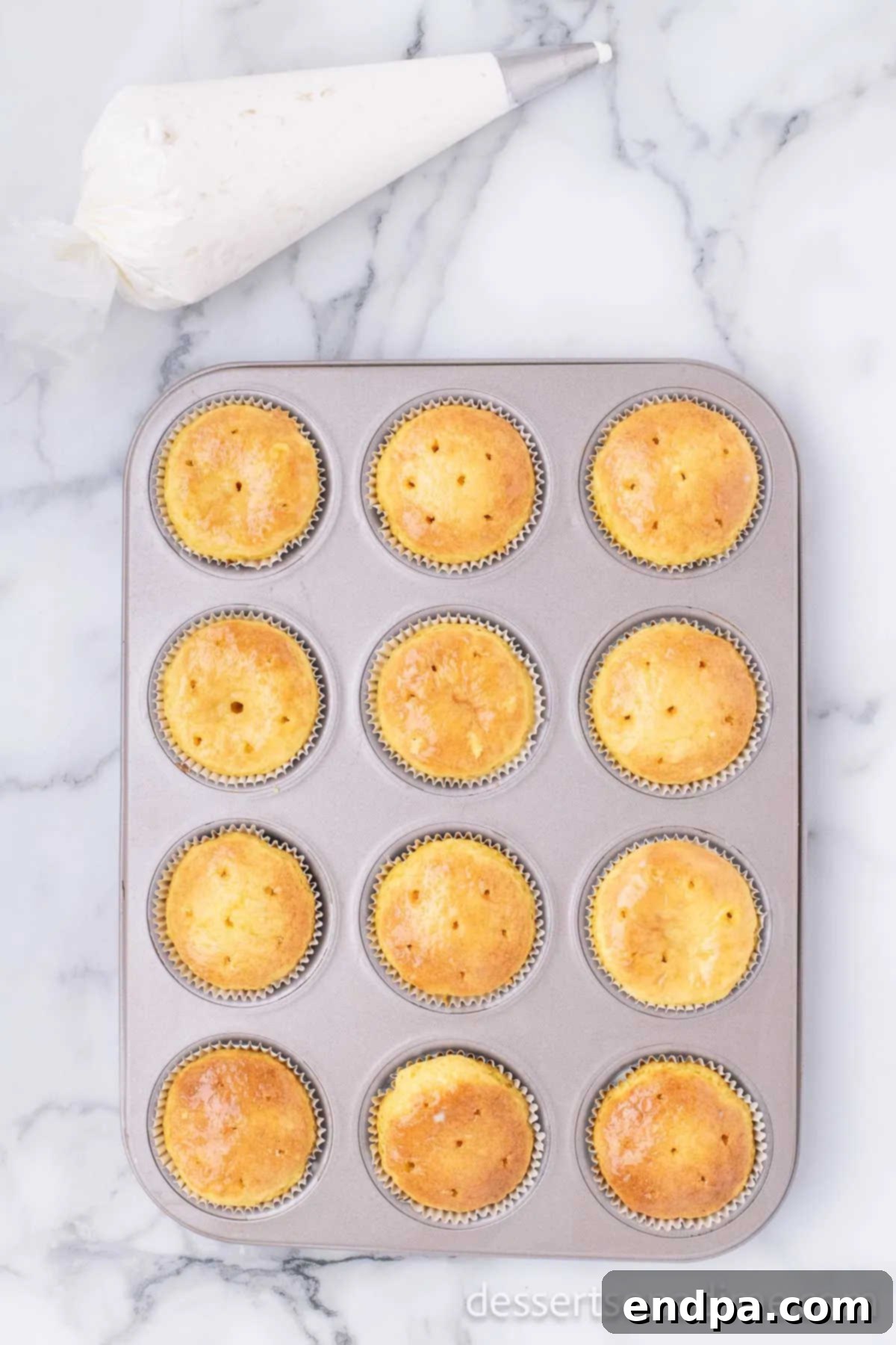 Cupcakes baked and holes poked. 