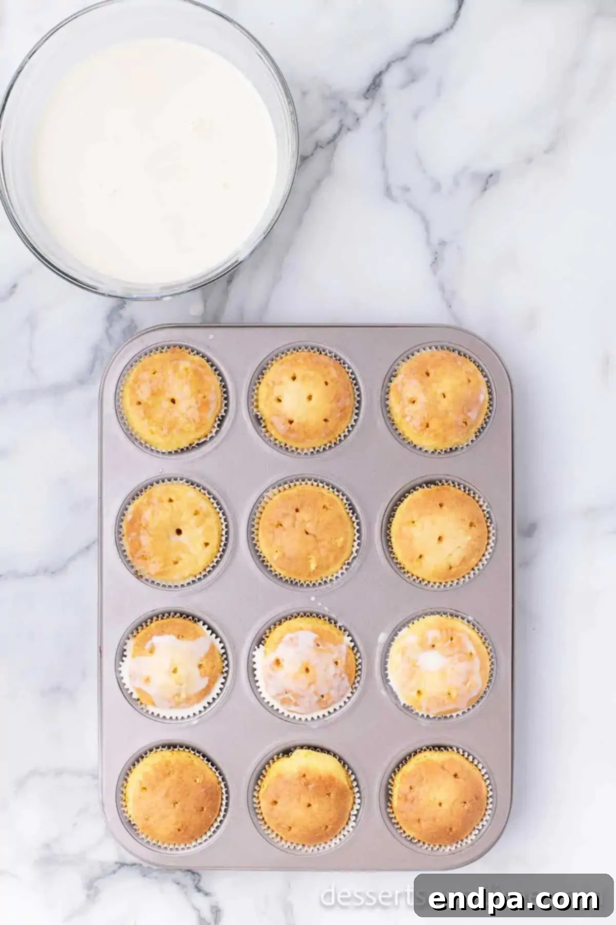 Milk spread over cupcakes. 