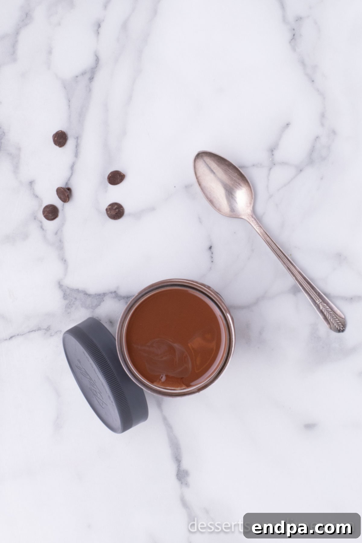 Homemade Hardening Chocolate Topping 5 Melted chocolate and coconut oil mixture in a container, ready to cool.
