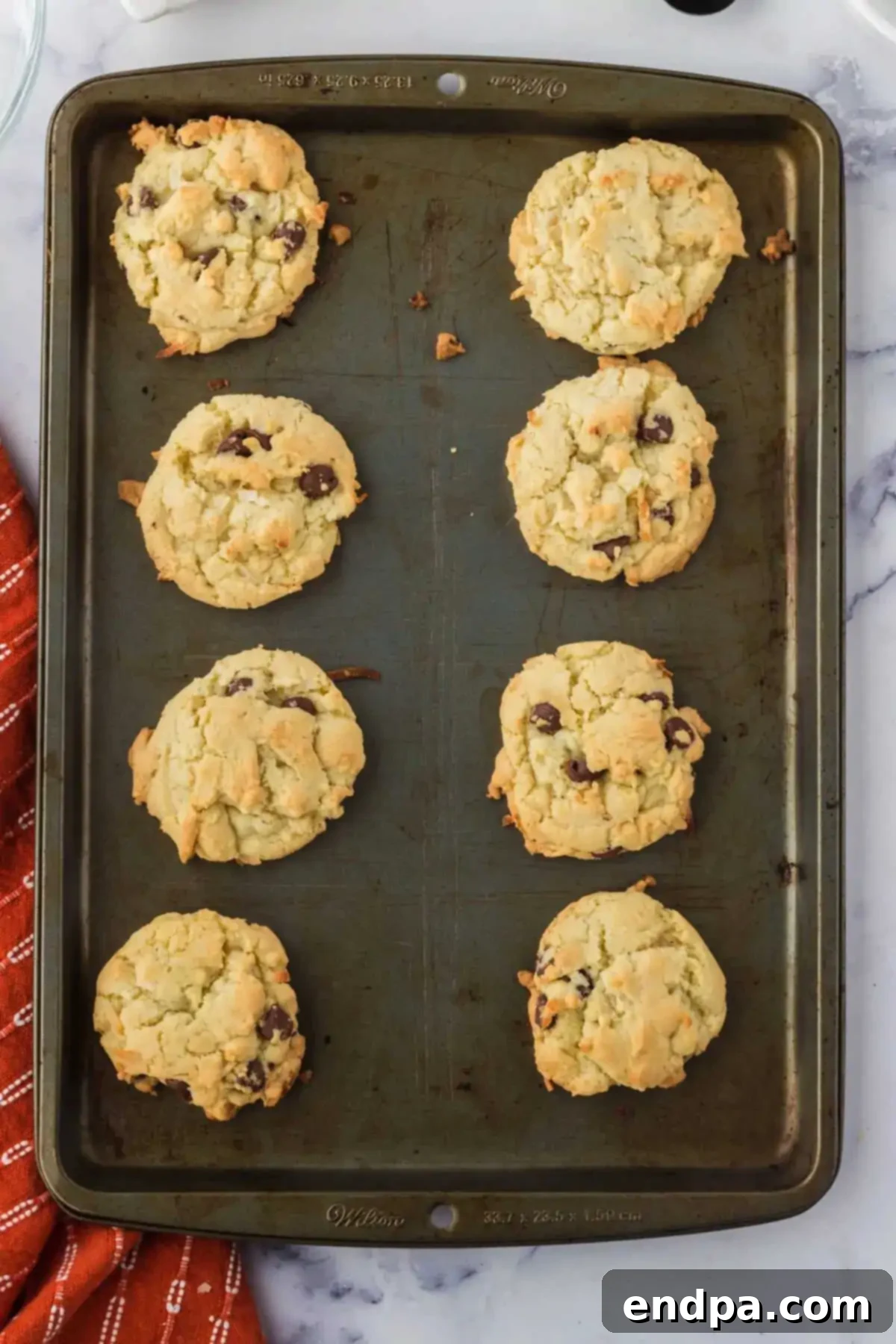 Chewy Coconut Chocolate Chip Dreams 9 Freshly baked cookies cooling on a wire rack.