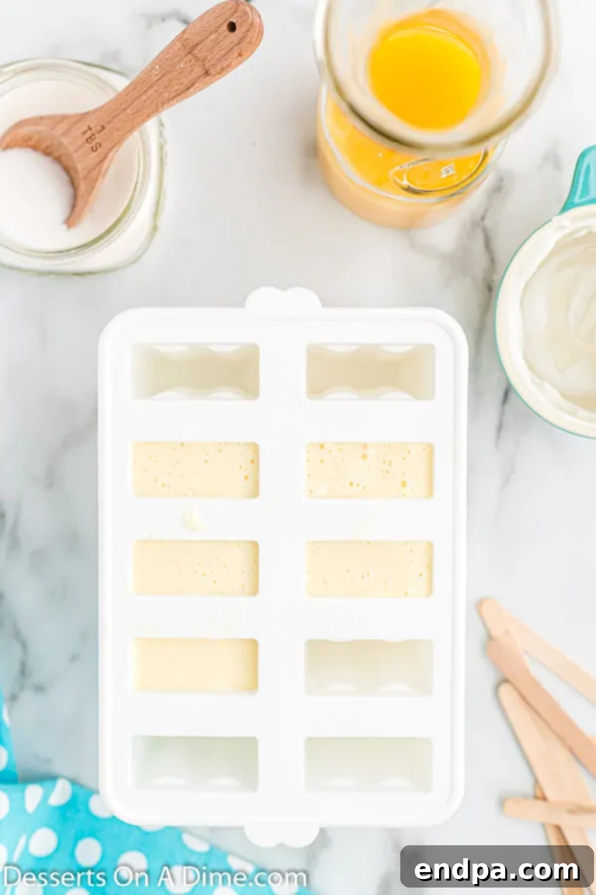 Orange Vanilla Swirl Pop 6 Mixture poured into molds.