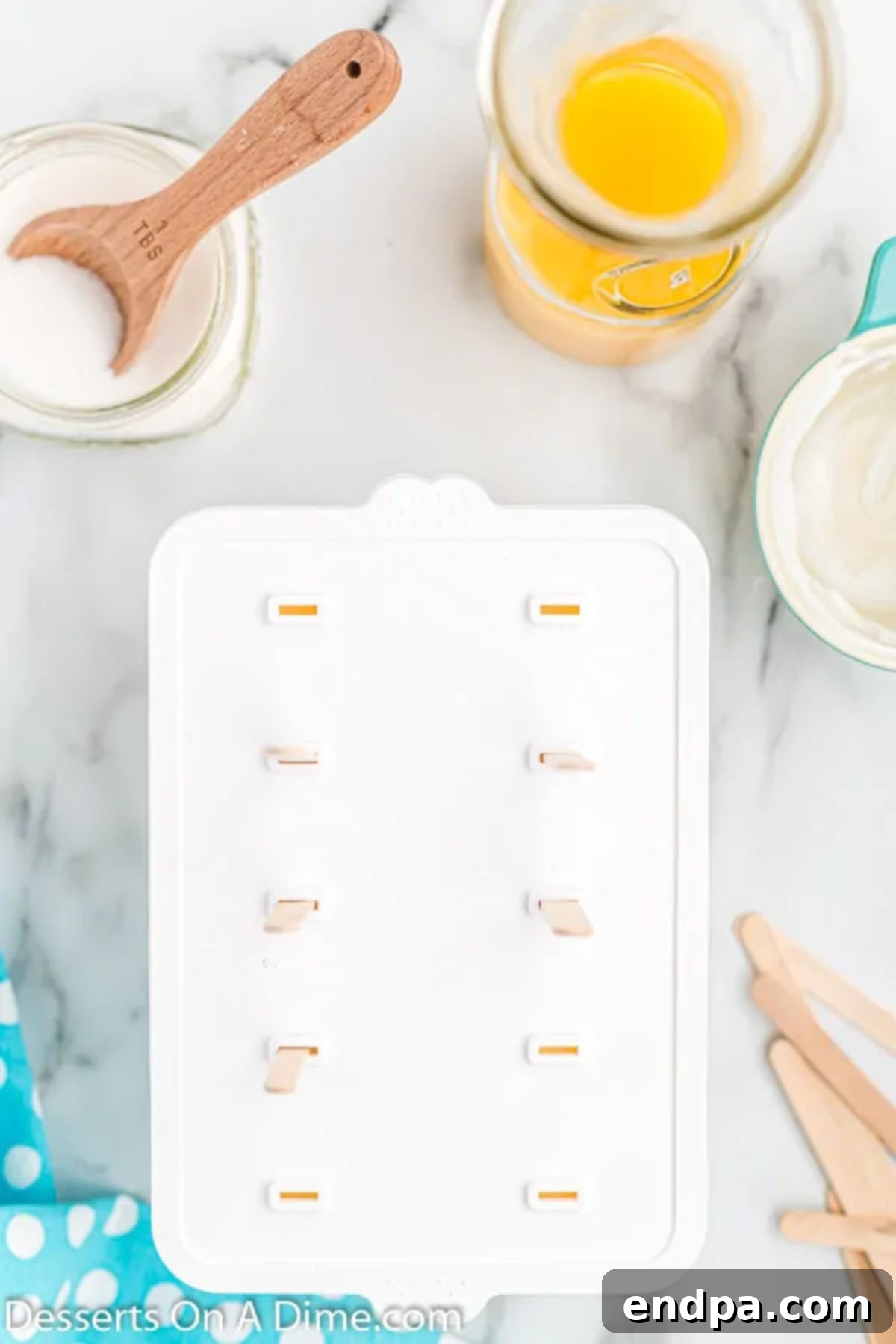 Orange Vanilla Swirl Pop 7 Molds with top on it.