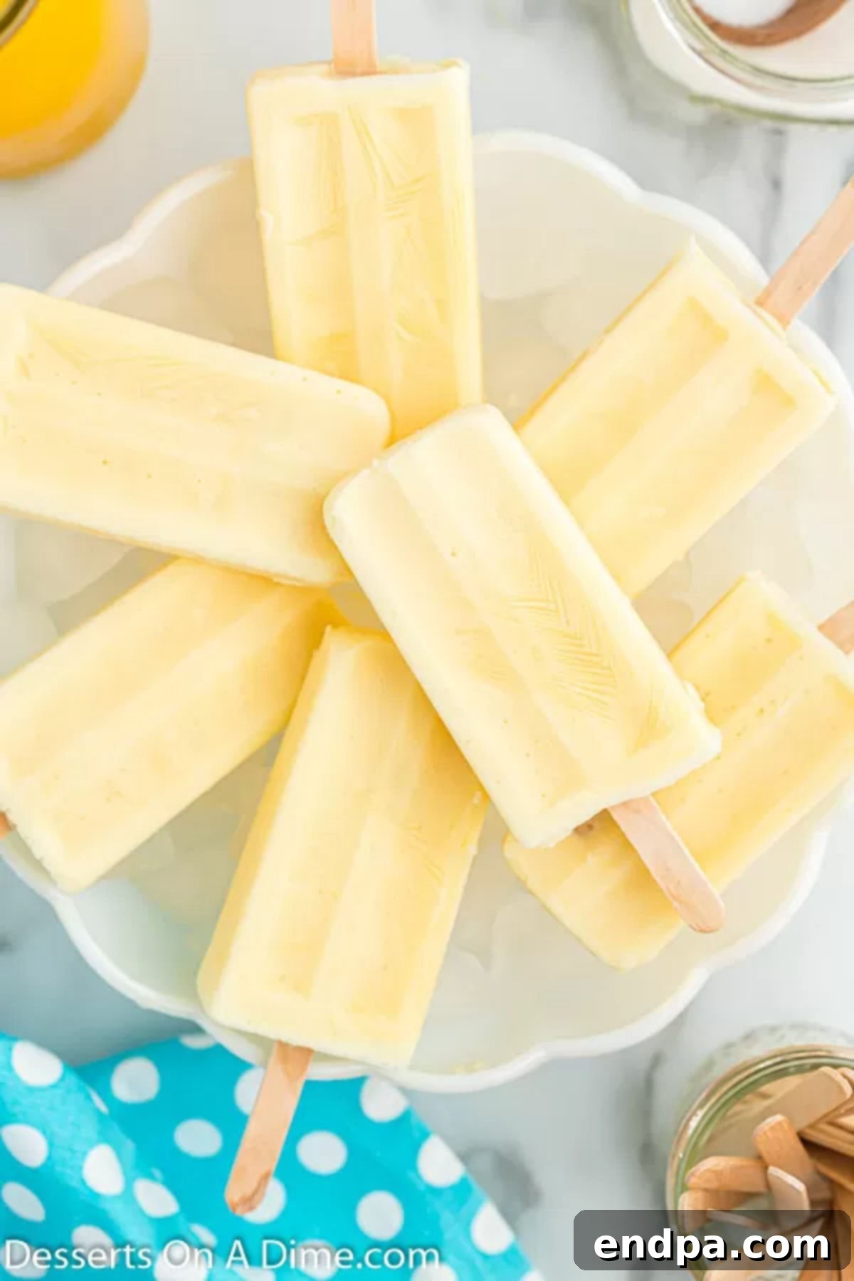 Orange Vanilla Swirl Pop 8 Orange creamsicle popsicles on a platter.