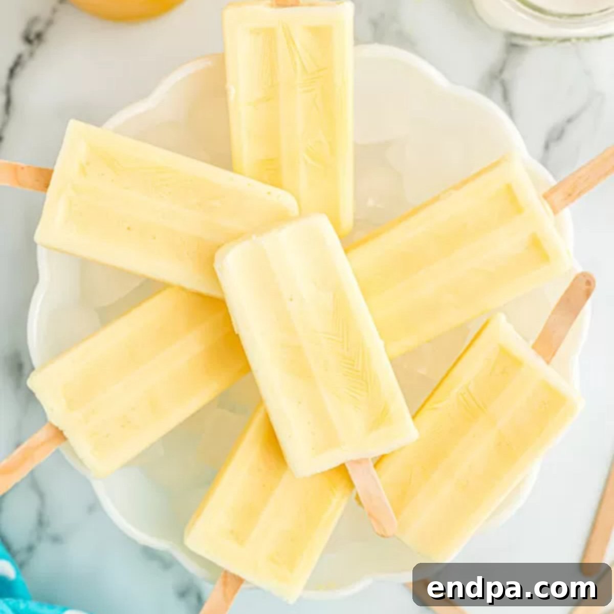 Orange Vanilla Swirl Pop 9 Popsicles on a plate.