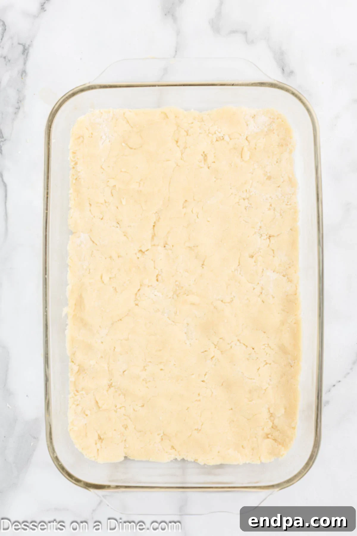 Perfectly Soft Sugar Cookie Bars 6 Cookie dough being pressed evenly into the prepared 9x13 inch baking pan.