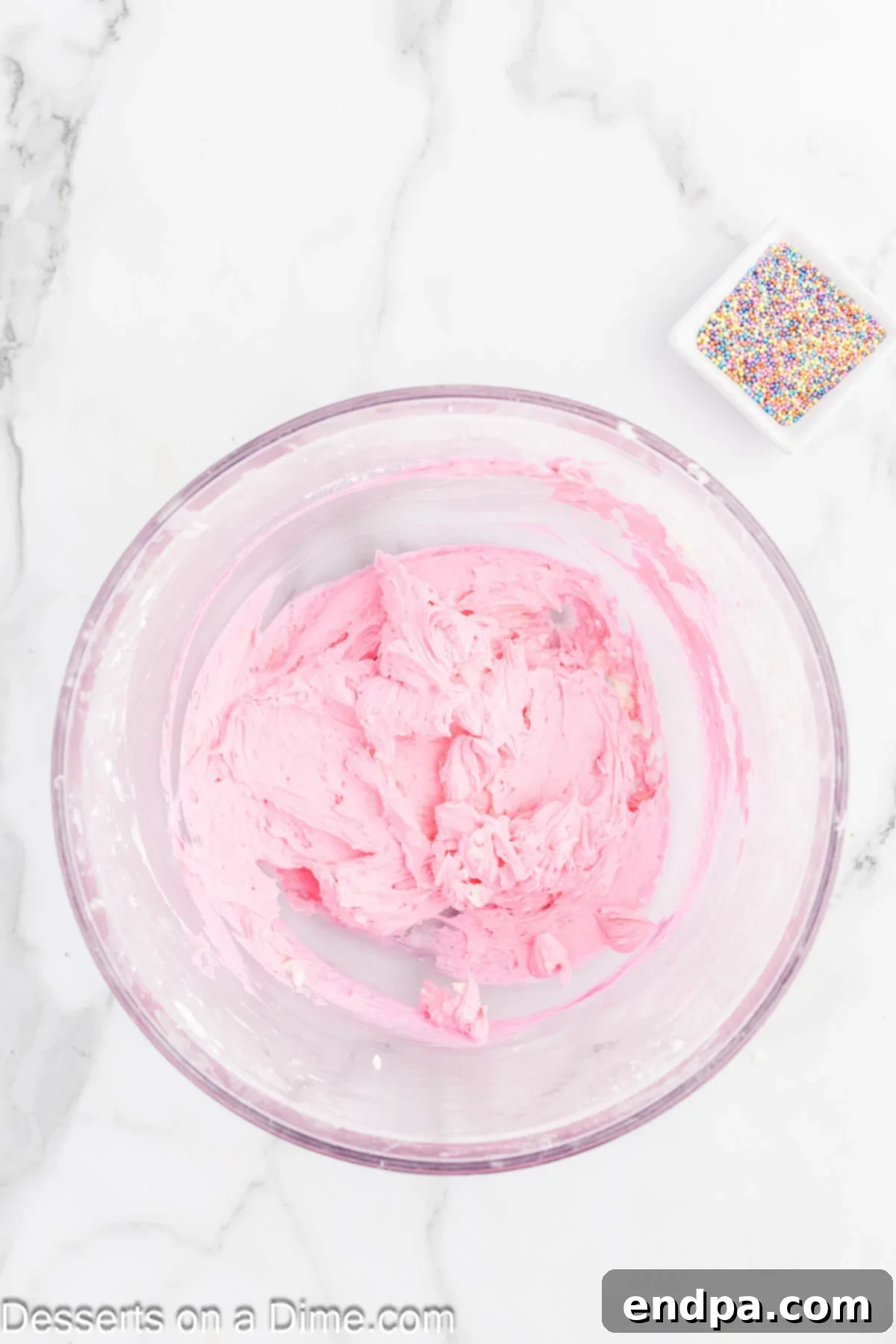 Perfectly Soft Sugar Cookie Bars 8 Food coloring being mixed into the creamy frosting.