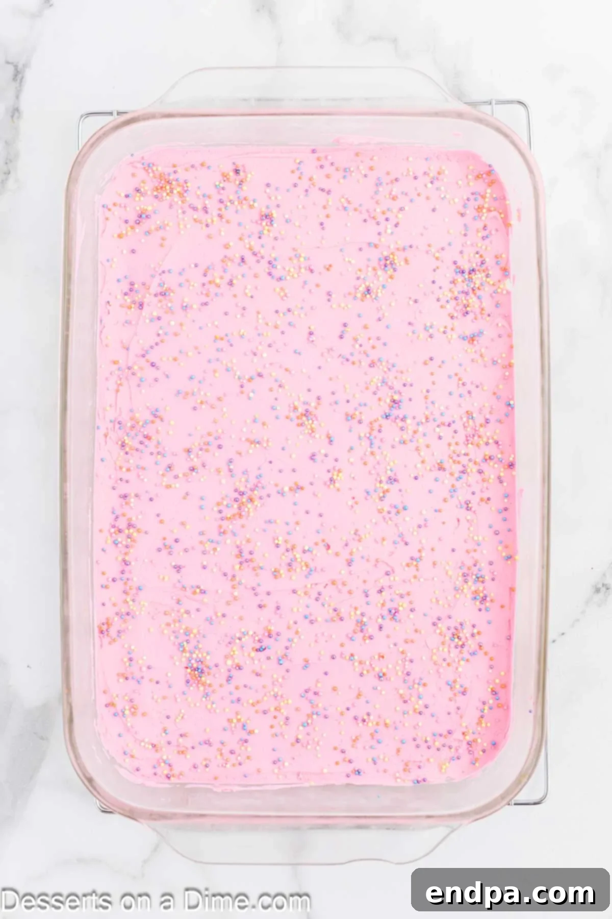 Perfectly Soft Sugar Cookie Bars 9 Generous layer of fluffy frosting being spread over the completely cooled sugar cookie bars.