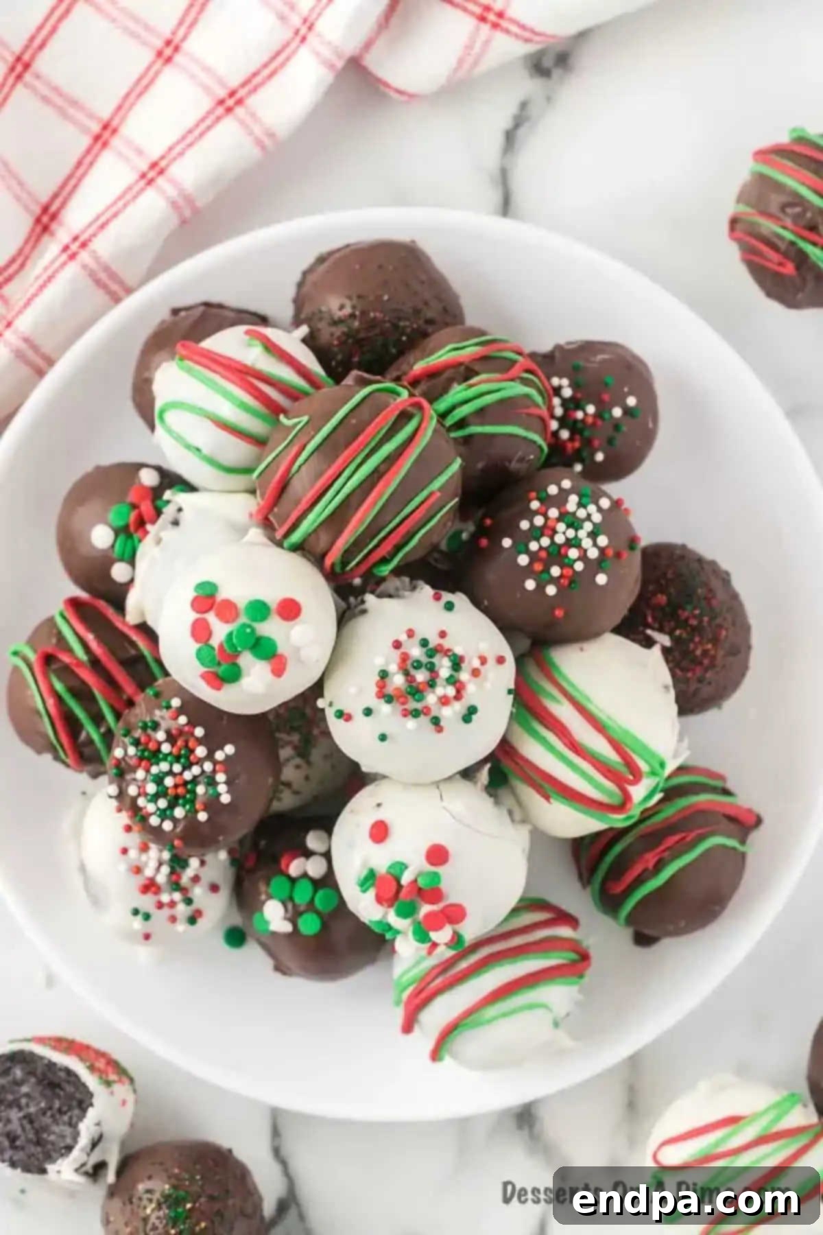 Irresistible Holiday Oreo Truffles 14 A vibrant platter of assorted Christmas Oreo Balls, some topped with green and red sprinkles, others with festive candy melt drizzles, showcasing a beautiful array of holiday treats.