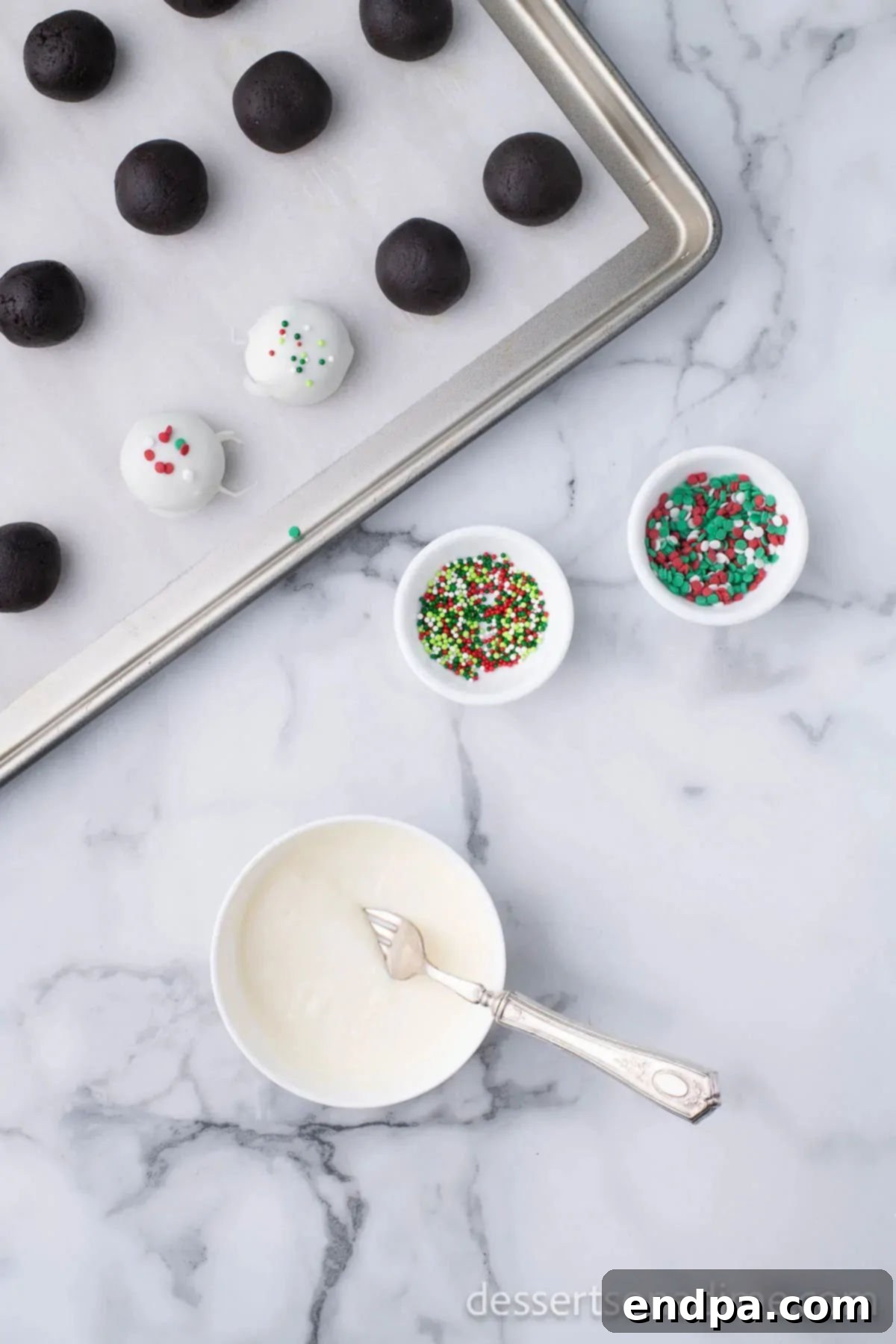 Irresistible Holiday Oreo Truffles 10 Freshly chocolate-dipped Oreo truffles are being adorned with a colorful array of Christmas sprinkles before the chocolate hardens.