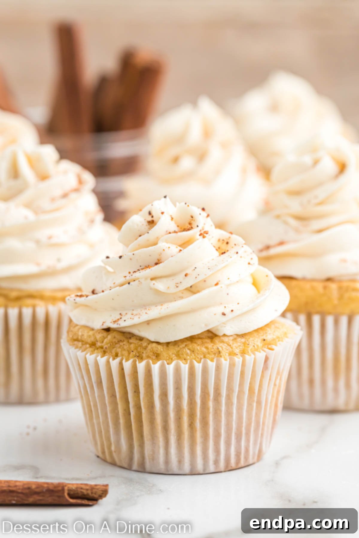 Festive Eggnog Cupcakes 2 Close-up view of a beautifully frosted Eggnog Cupcake, garnished with a sprinkle of nutmeg, highlighting its festive appeal.
