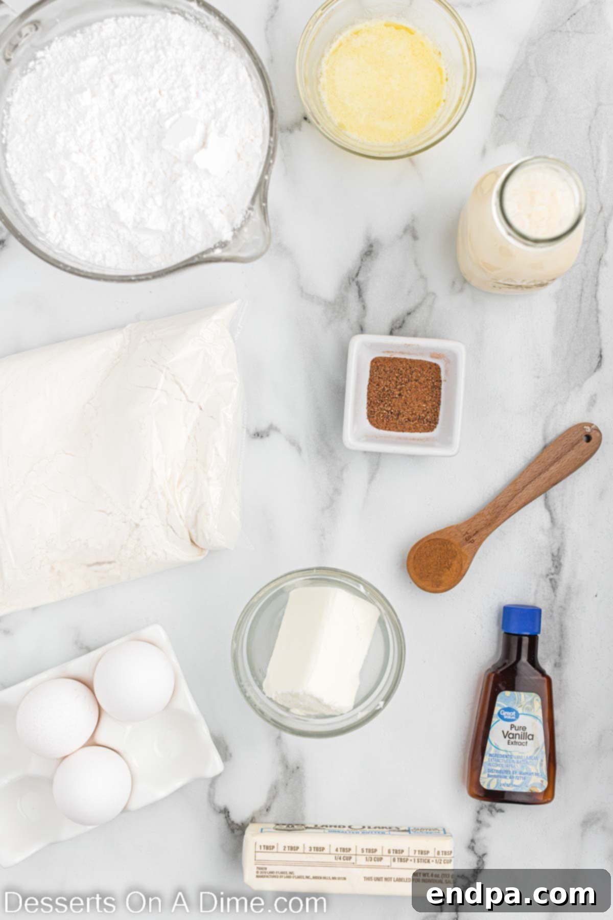 Festive Eggnog Cupcakes 3 A selection of ingredients laid out for baking Eggnog Cupcakes, including cake mix, eggs, oil, vanilla, butter, nutmeg, and a carton of eggnog.
