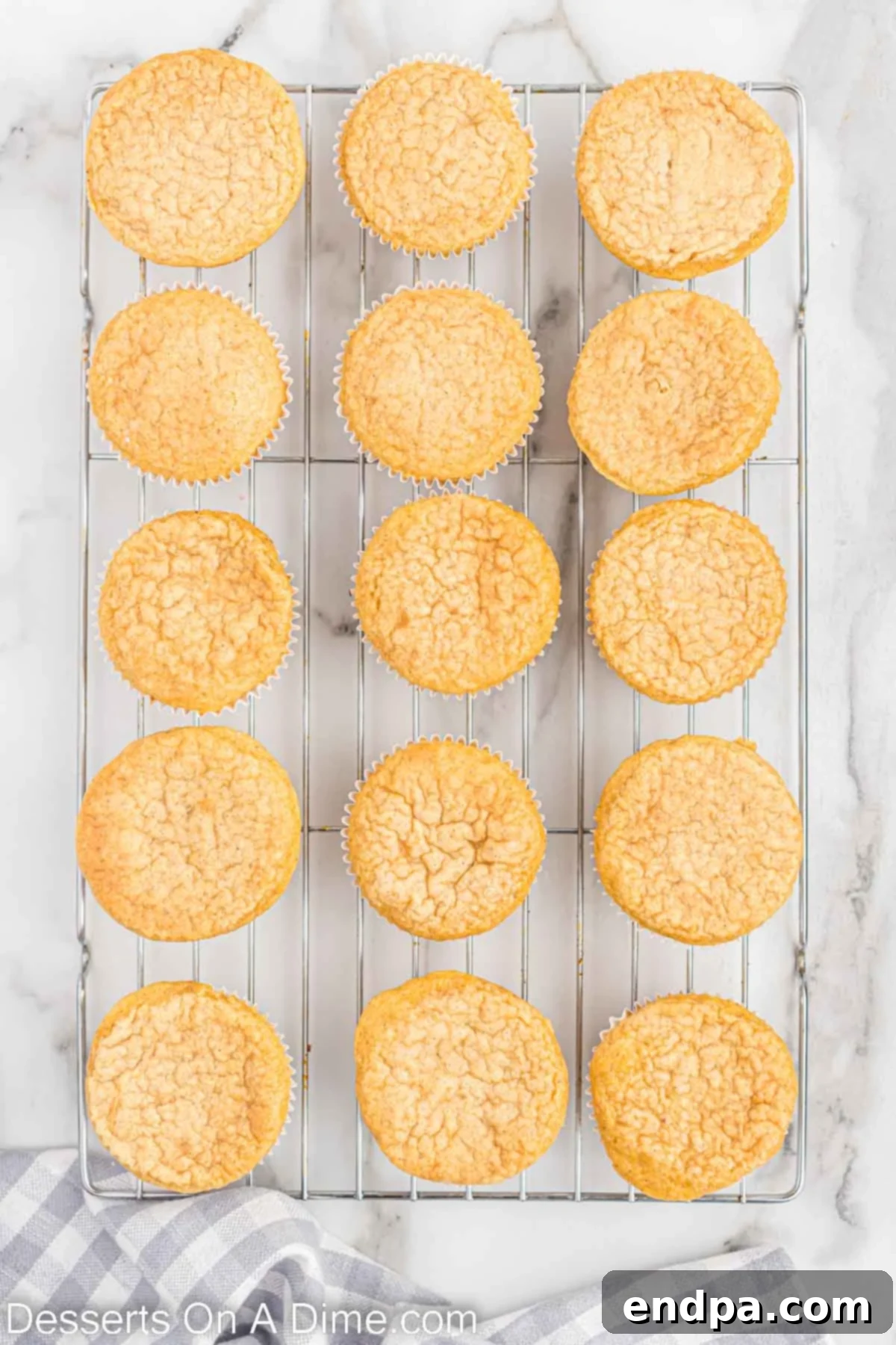 Festive Eggnog Cupcakes 8 Baked Eggnog Cupcakes cooling completely on a wire rack.