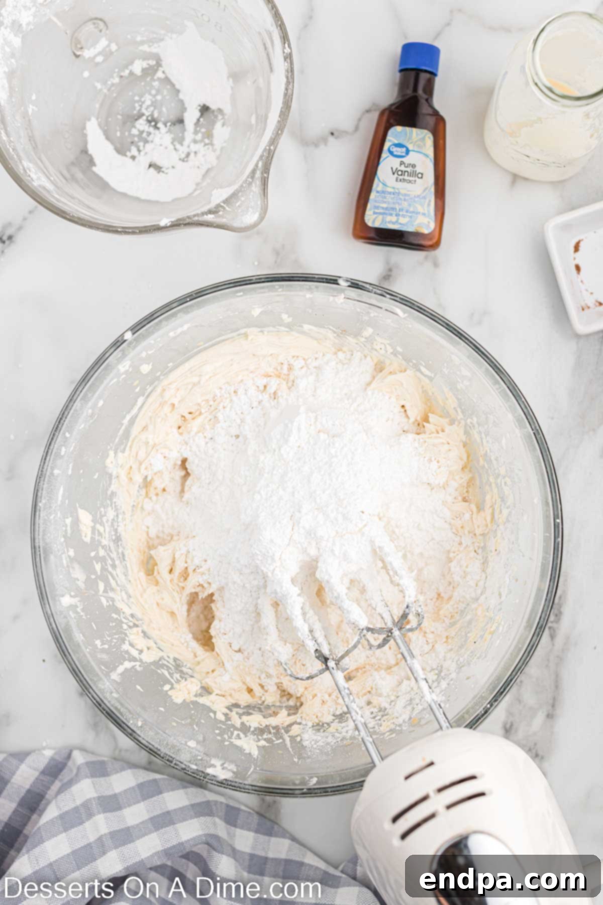 Festive Eggnog Cupcakes 10 Powdered sugar partially incorporated into the butter and shortening mixture in a bowl.