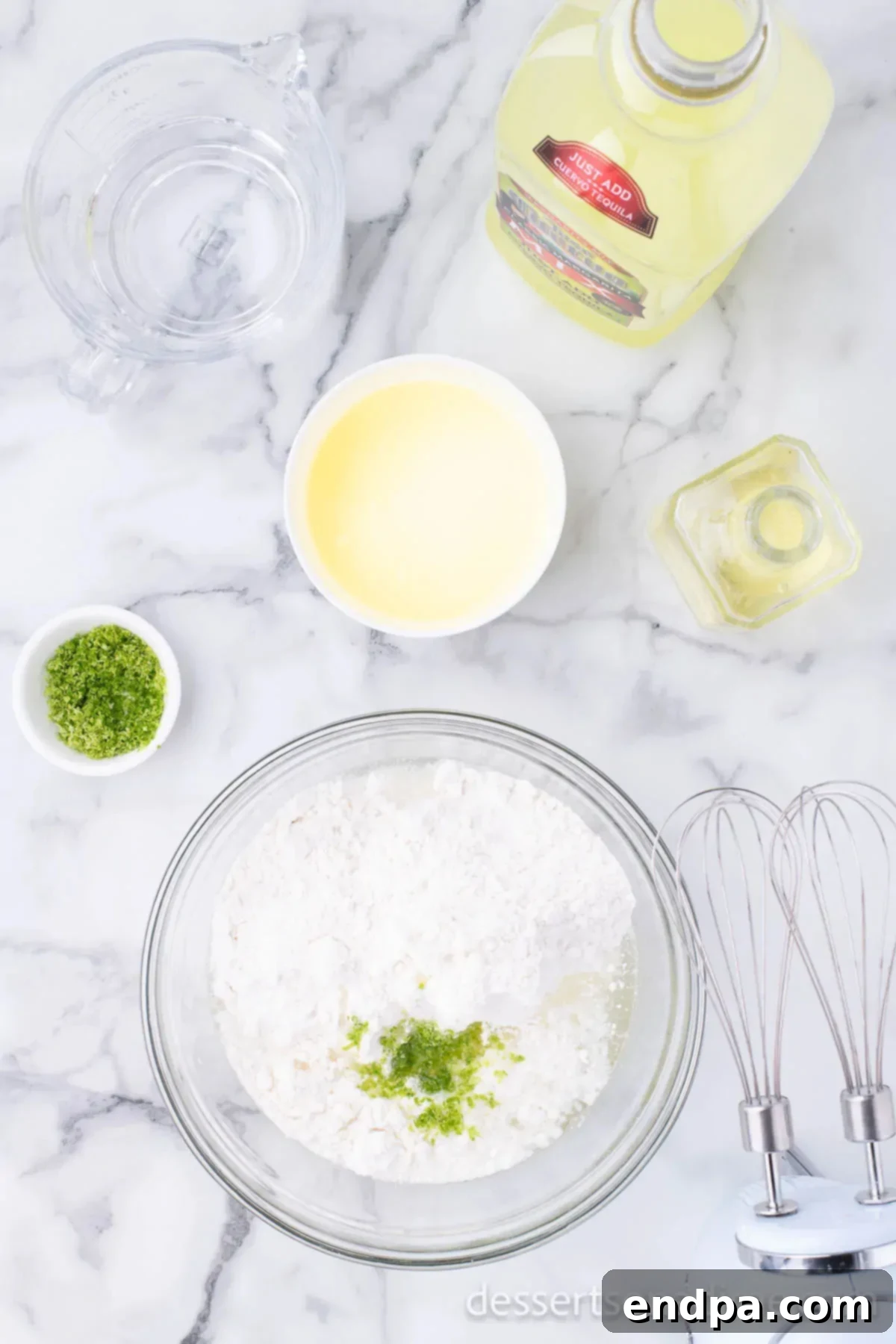 Mixing bowl with powdered sugar and lime zest, ingredients for the frosting.