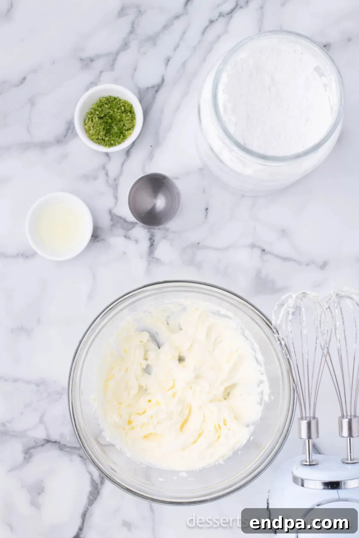 Frosting ingredients combined in a bowl, showing a smooth, creamy texture.