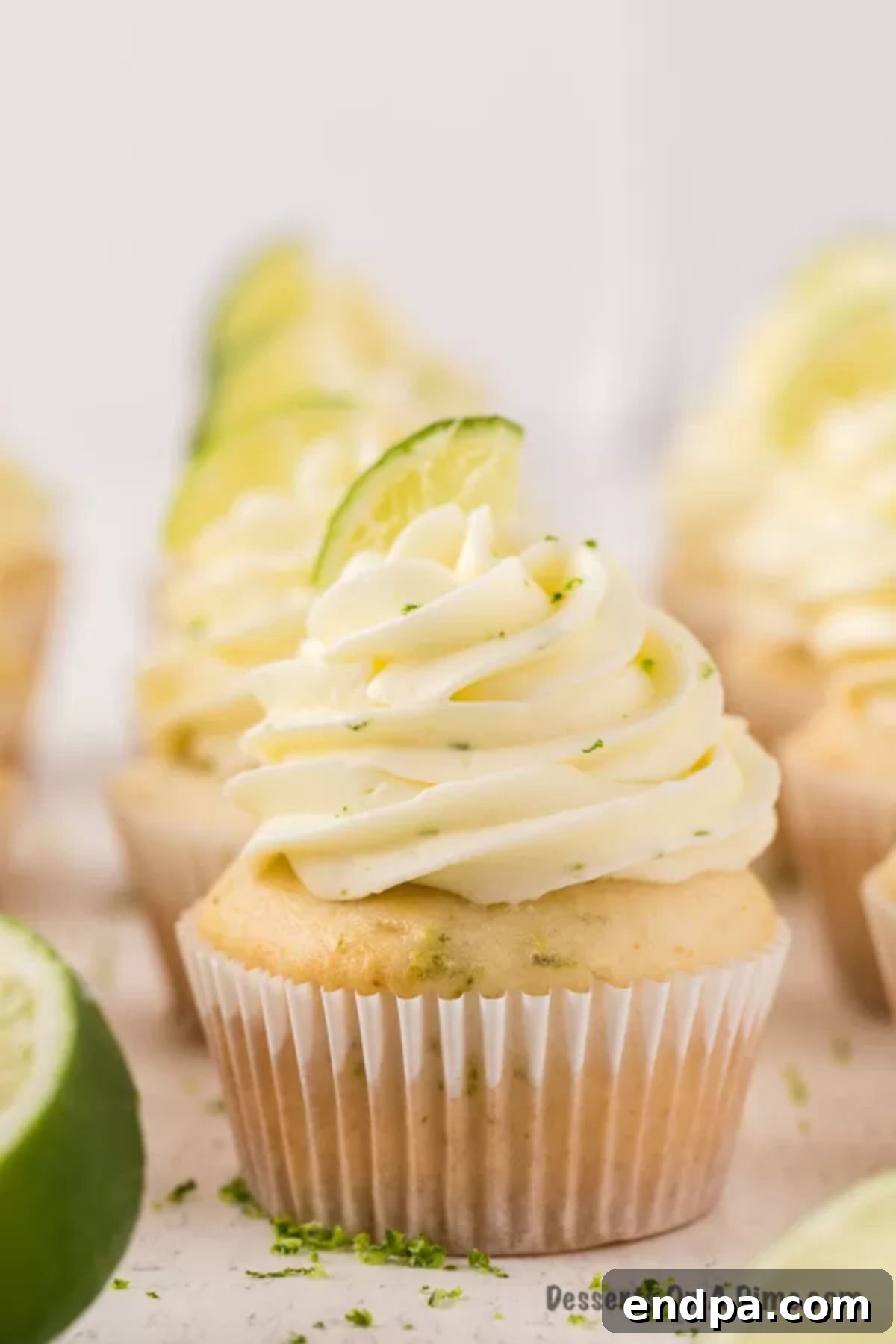 Tequila Lime Cupcakes 2 A close up image of margarita cupcakes with slices of fresh lime