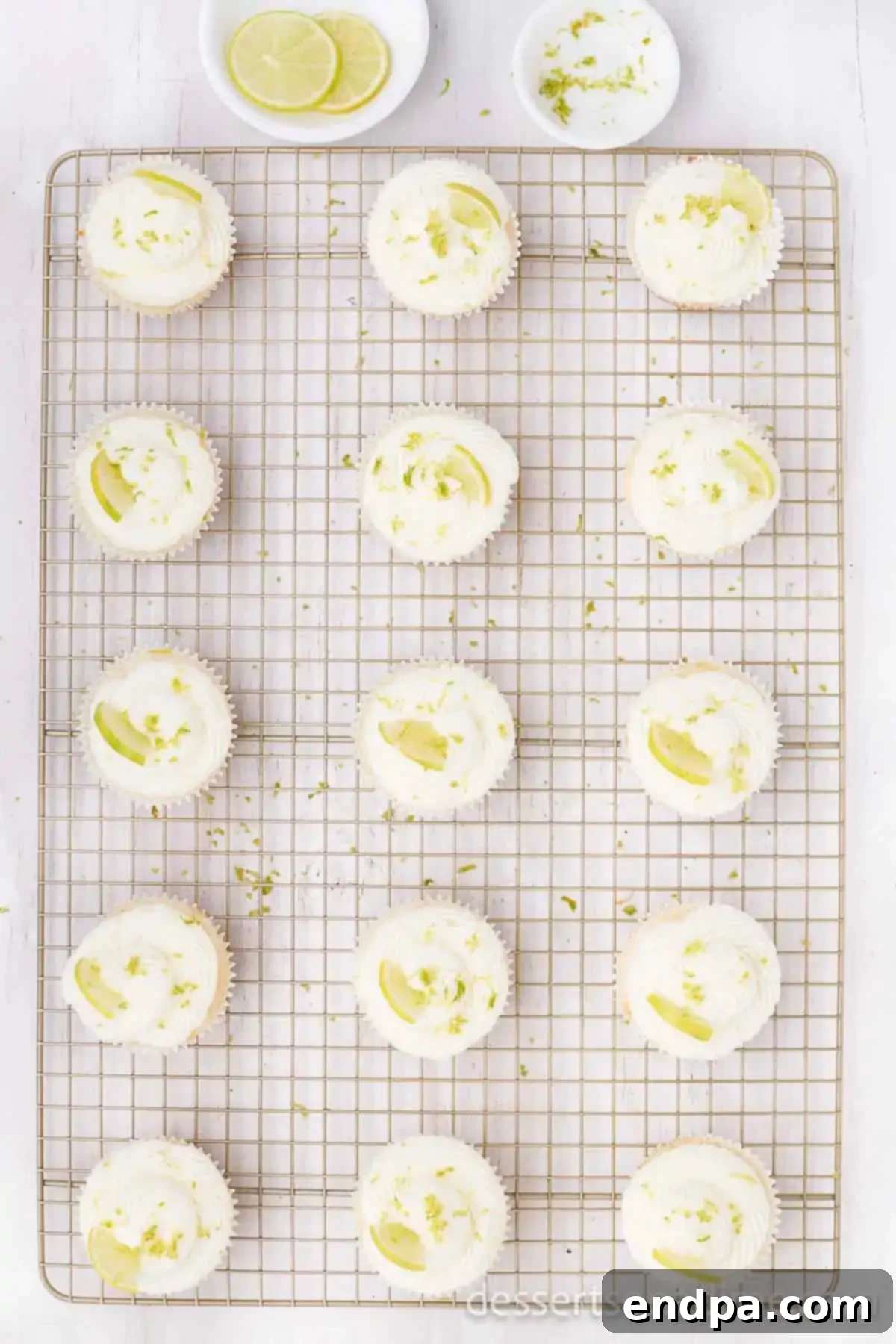 Tequila Lime Cupcakes 9 Cupcakes topped with frosting and garnished with a lime.