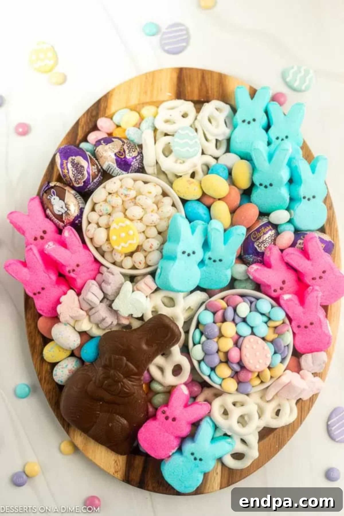 A festive Easter Candy Charcuterie Board laden with colorful candies, chocolate bunnies, and Peeps.