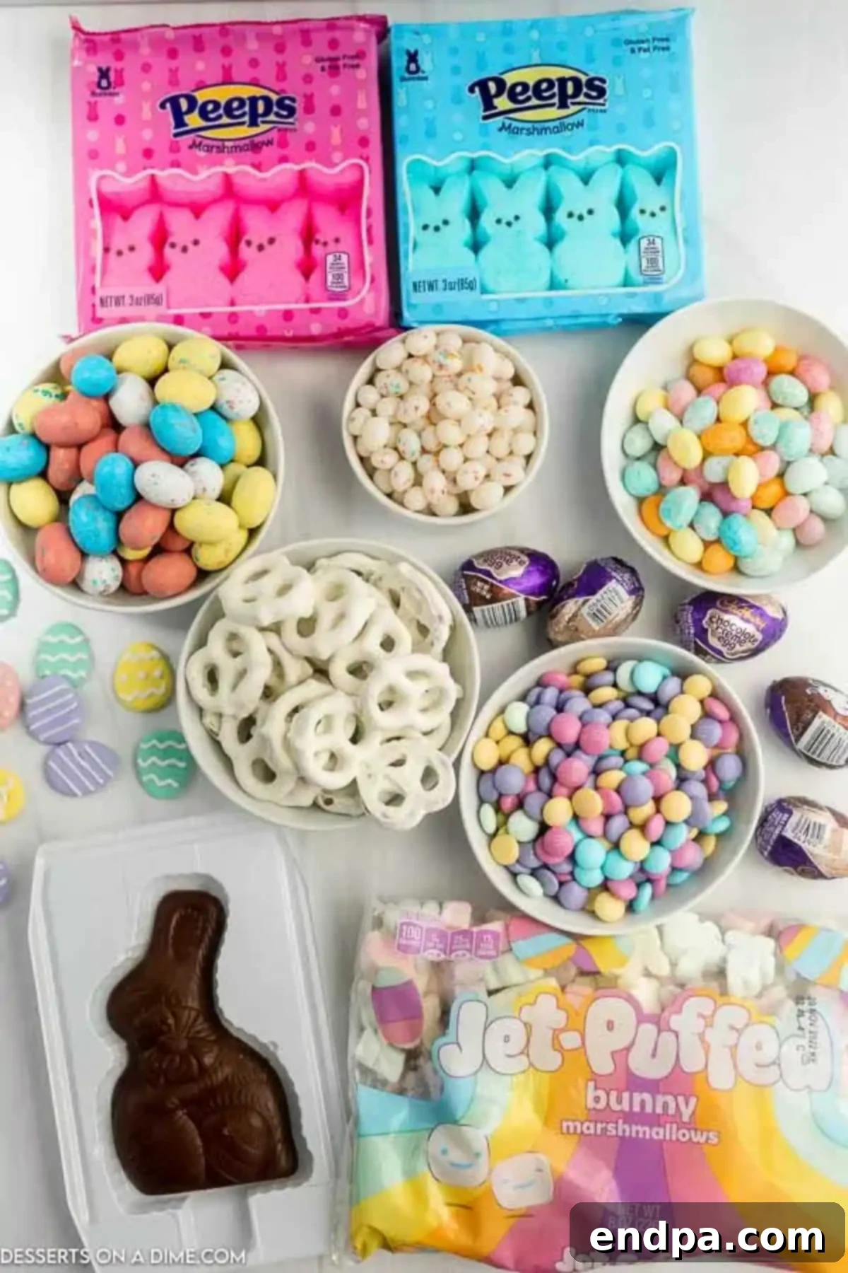 Ingredients needed to make an Easter Candy Charcuterie Board, including various Peeps, pretzels, egg-shaped candies, jelly beans, M&M's, marshmallows, and a chocolate Easter bunny.