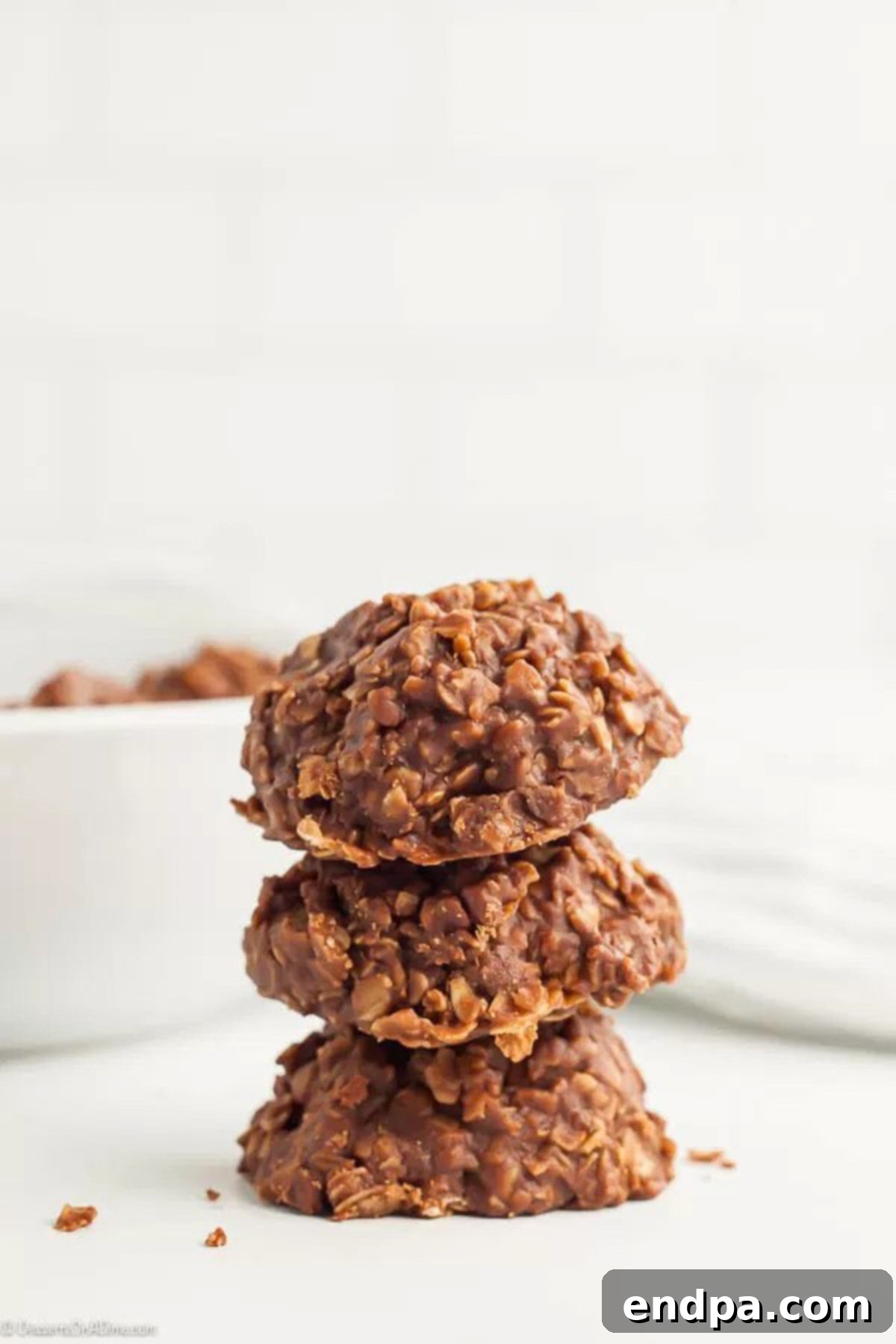 This Easy No Bake Cookies Recipe is simple to make and has a tasty combination of peanut butter and chocolate. Anytime we want a treat fast, we make this! No Bake Cookies stacked together, showcasing their tempting texture.
