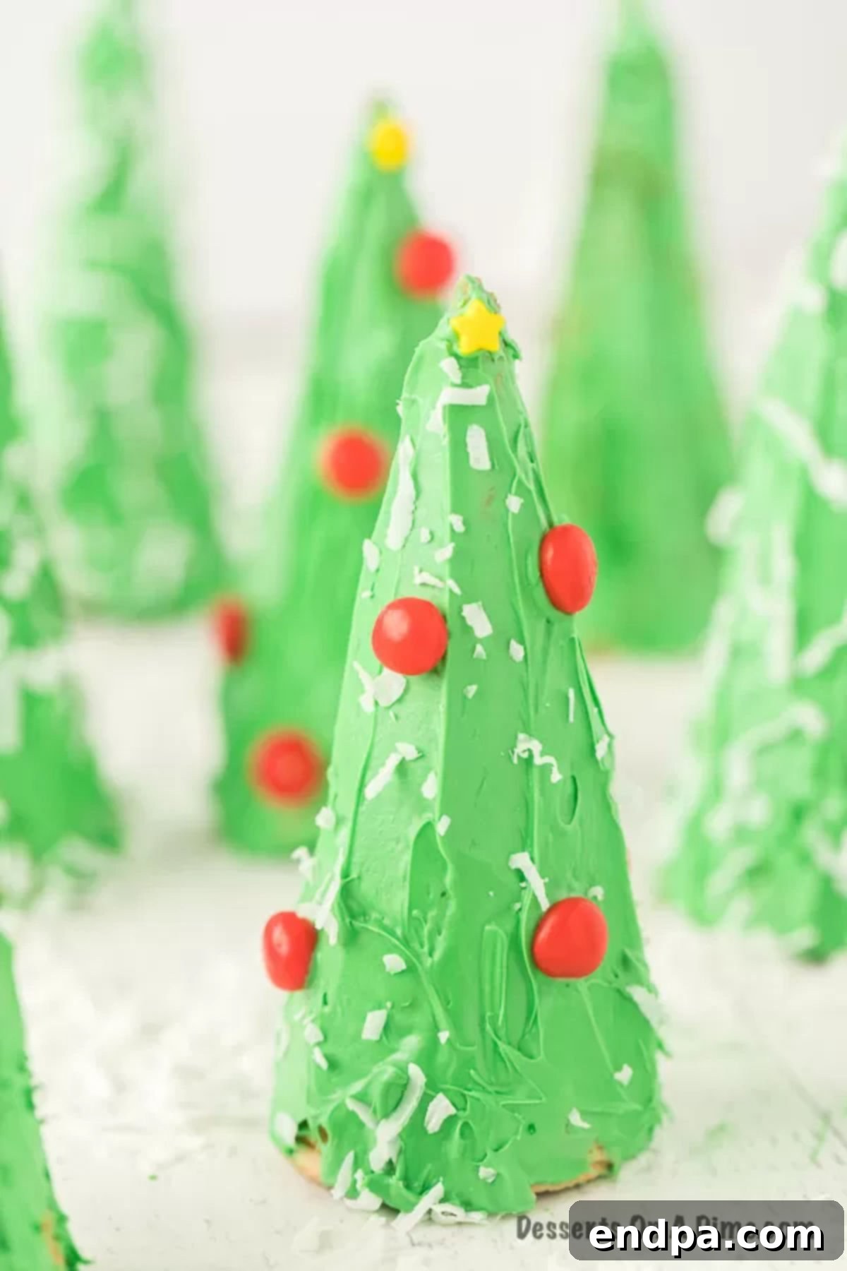 Ice Cream Cone Christmas Trees decorated with colorful candies and frosting.