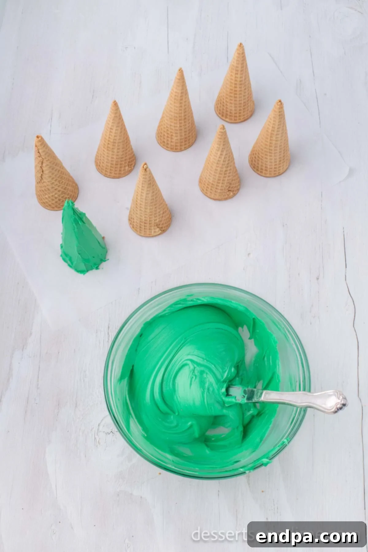 Green frosting mixed thoroughly in a bowl.