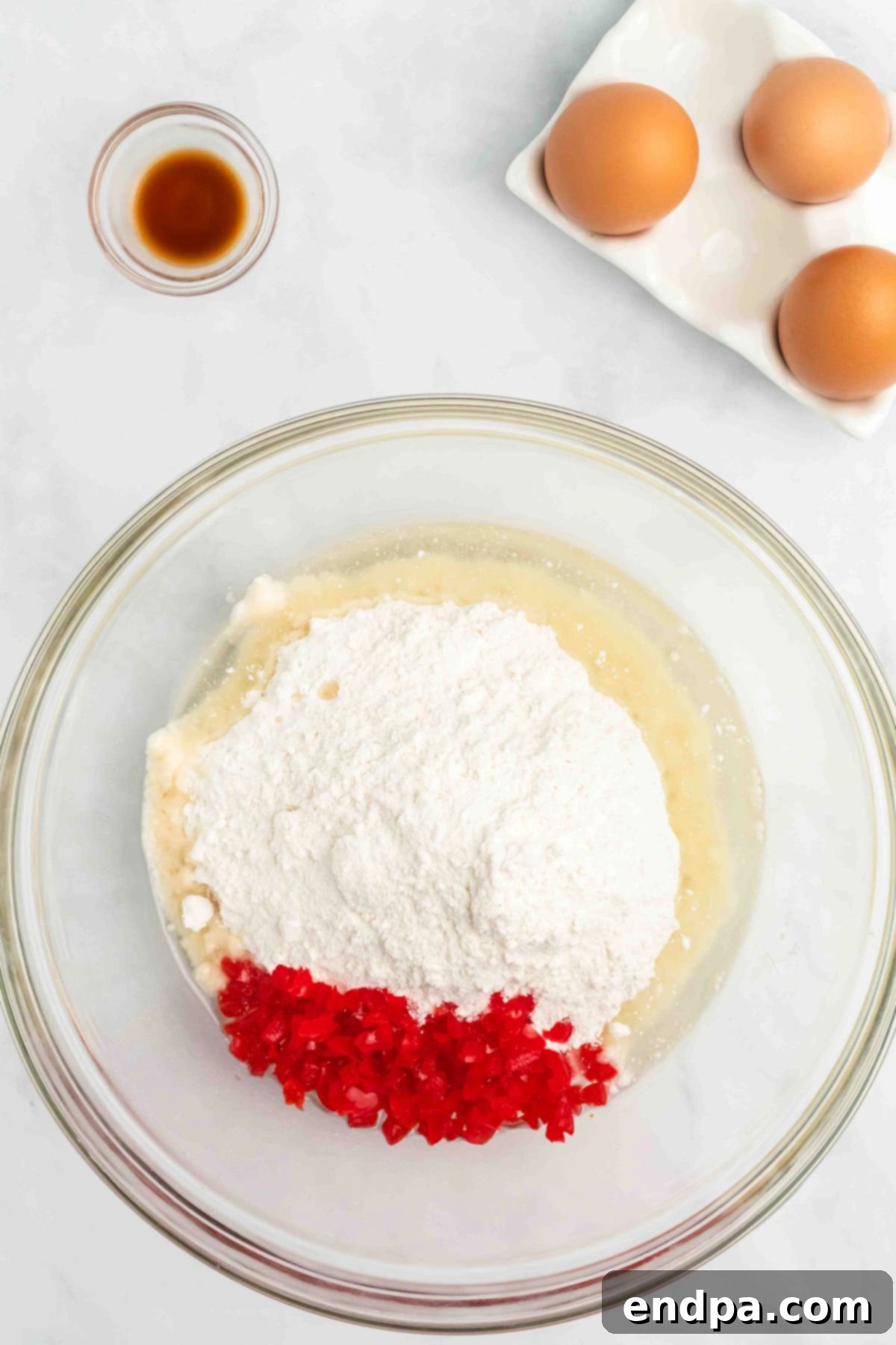 Mixing bowl with cherries, cake mix and wet ingredients.