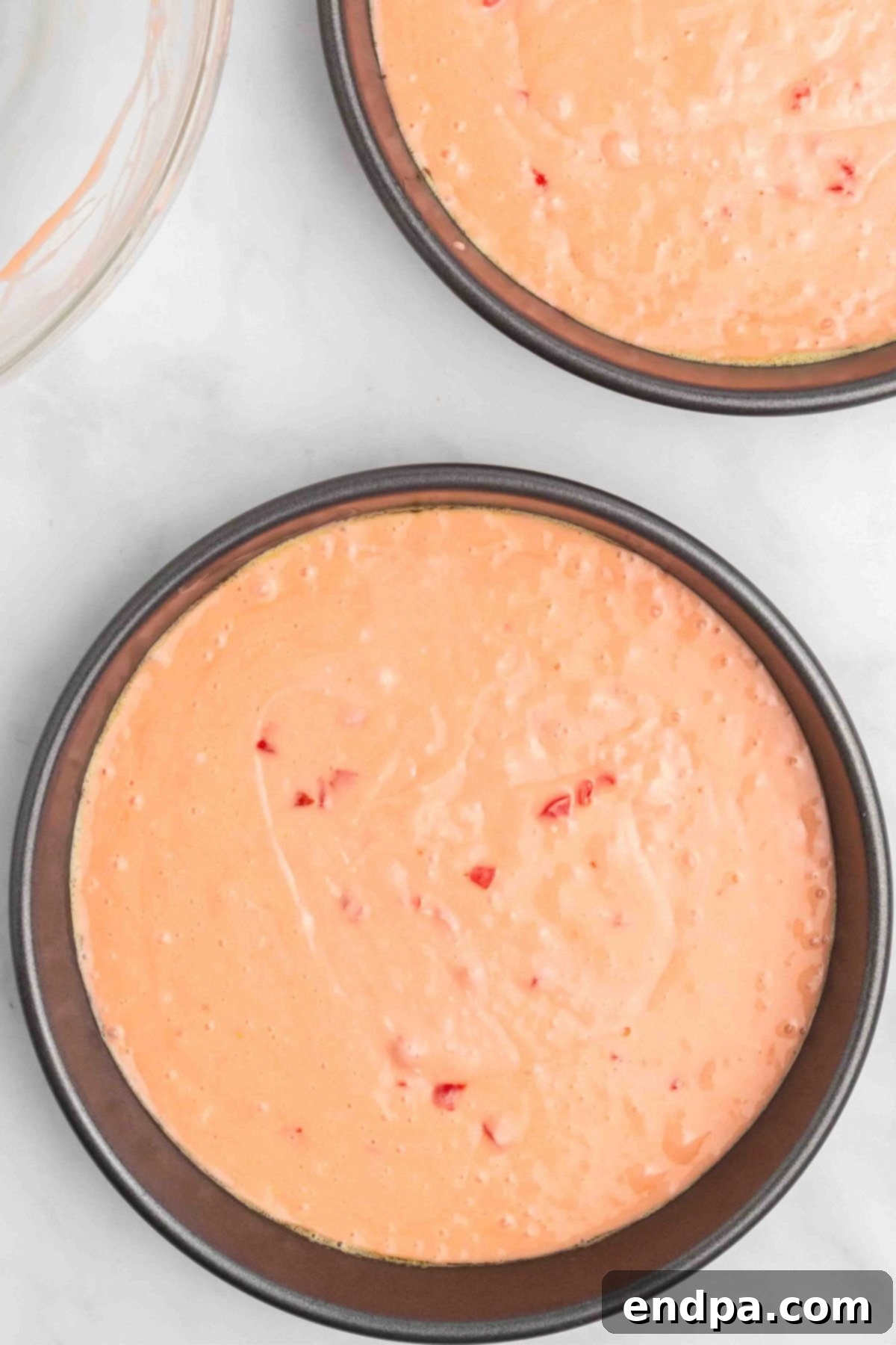 Batter poured into cake pans.