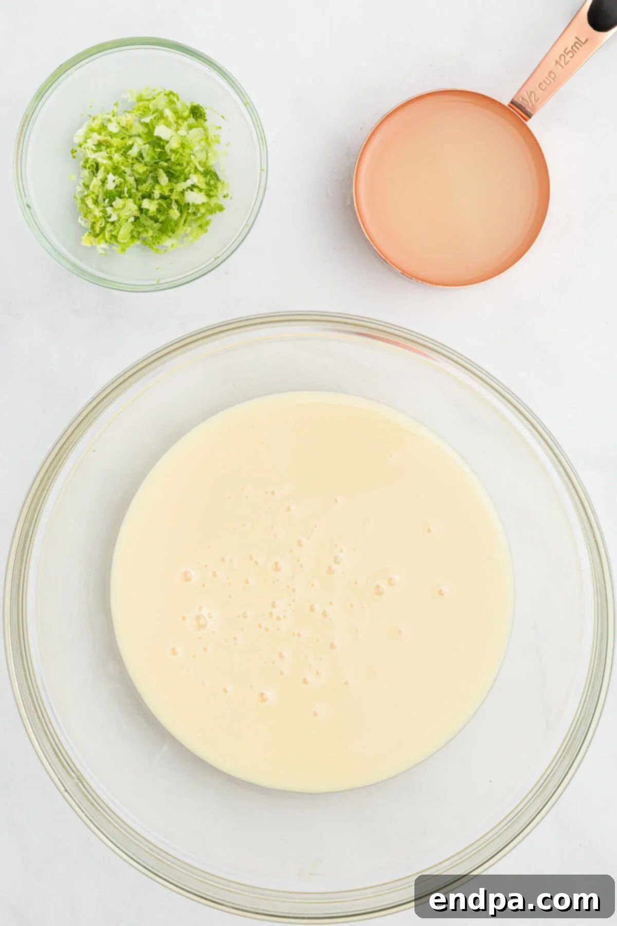 Sweetened condensed milk mixture in a bowl, ready to be combined.