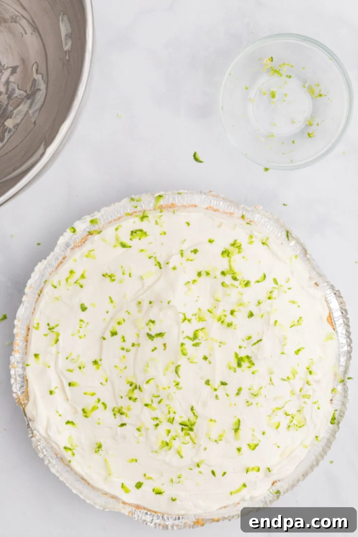 Margarita pie filling spread evenly into a graham cracker pie crust.