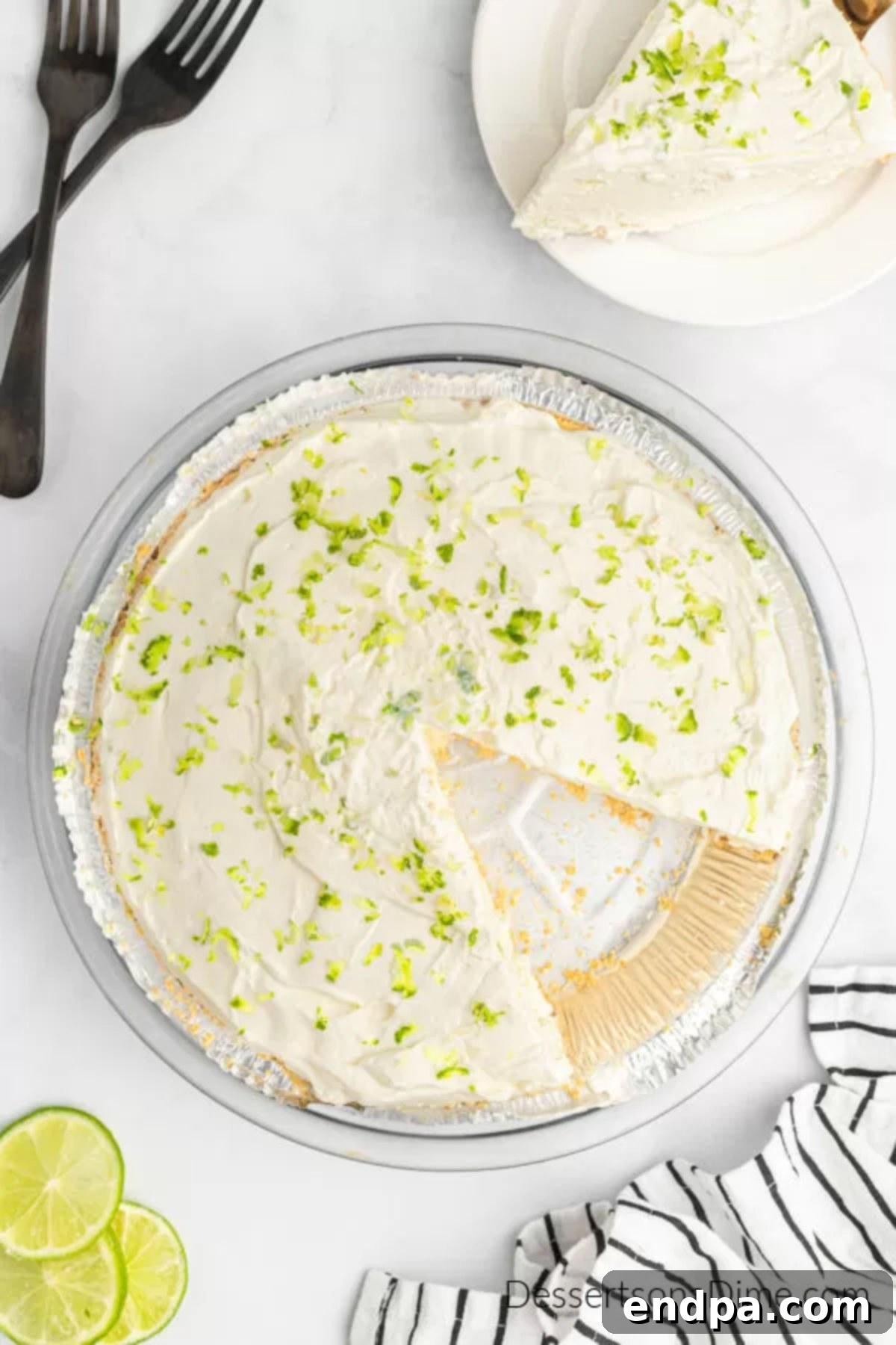 A slice of Margarita pie being served, garnished with lime.
