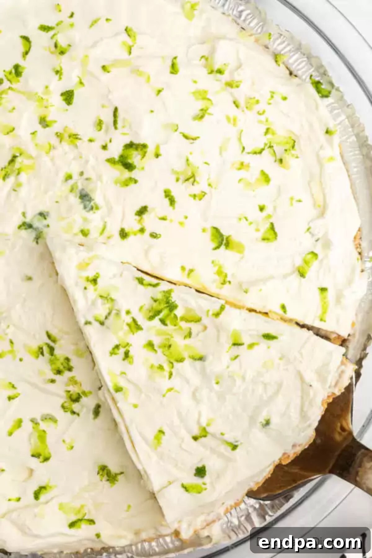 Margarita pie in pie plate being served, showing its complete form.