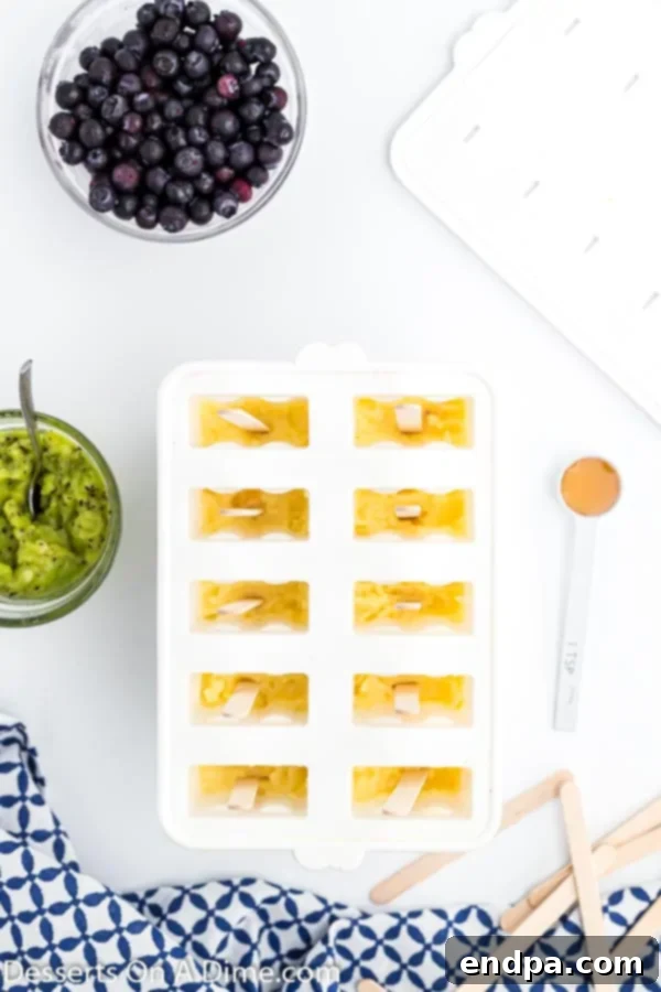 Frozen Rainbow Delights 6 Pineapple layer added to each mold, creating a distinct yellow stripe.