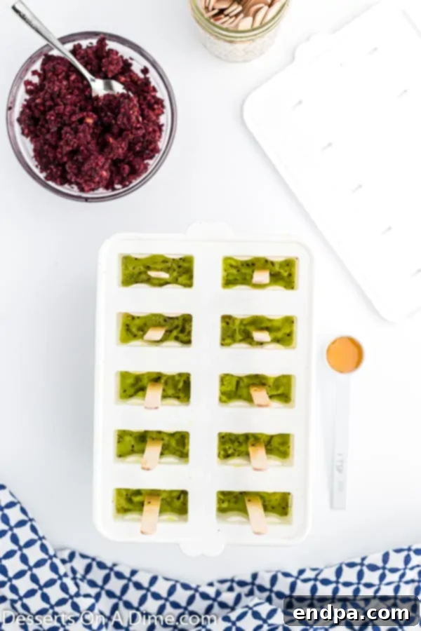 Frozen Rainbow Delights 7 Kiwi layer added into the mold, showcasing the green layer.