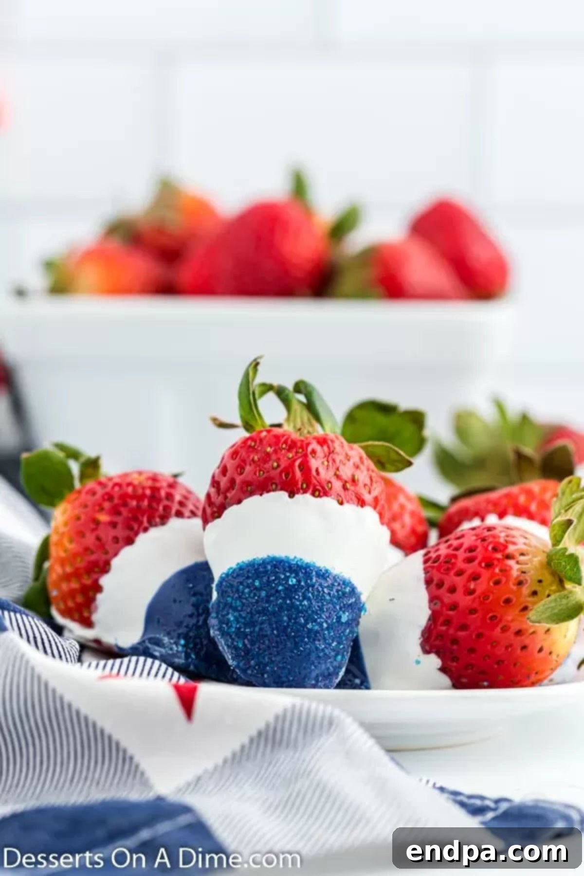 An inviting platter showcasing an assortment of red, white, and blue dipped strawberries, ready for a festive gathering.