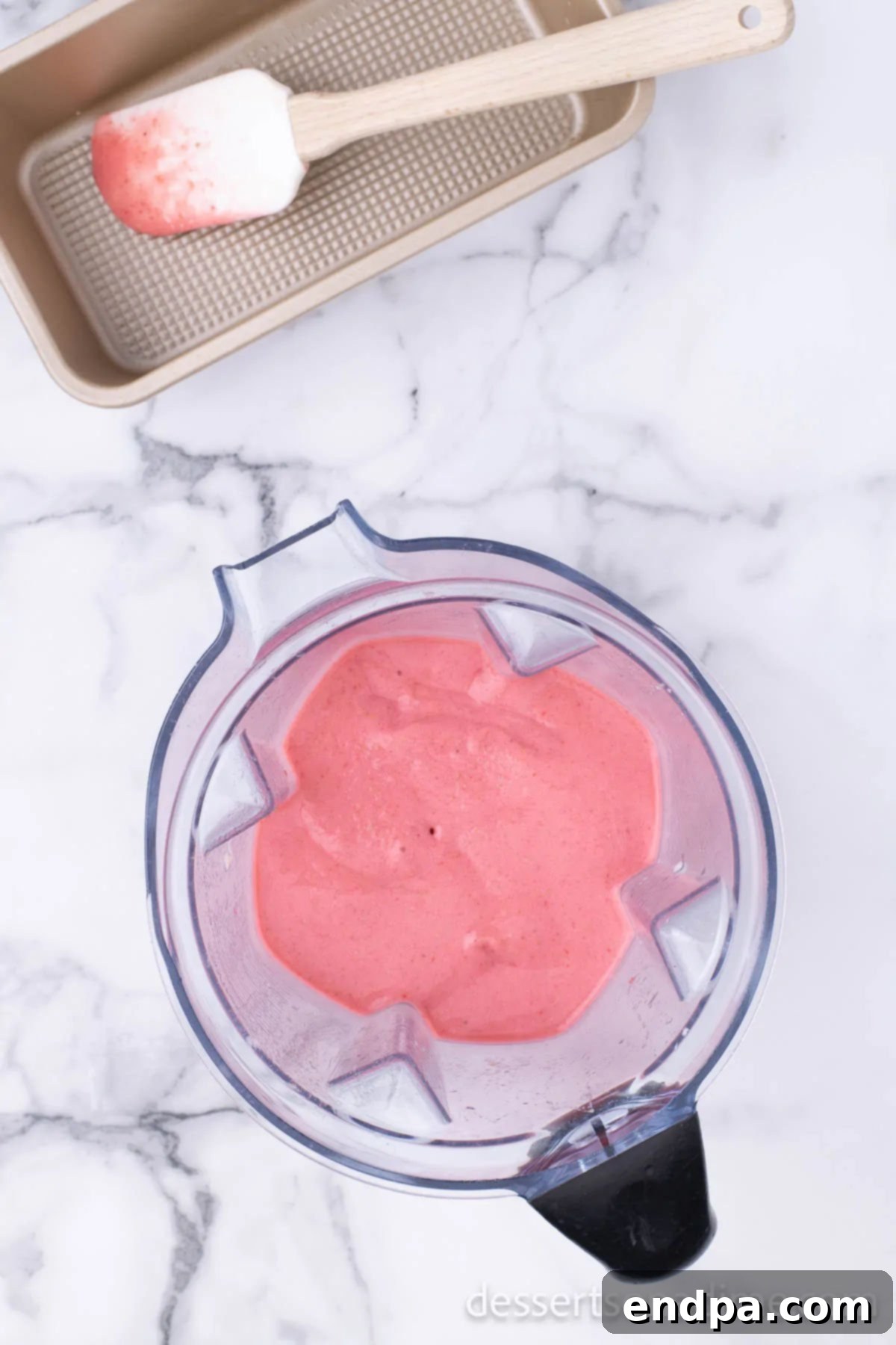 Fruity Frozen Delights 5 The fruit mixture being pureed in the blender until it reaches a smooth, consistent texture.